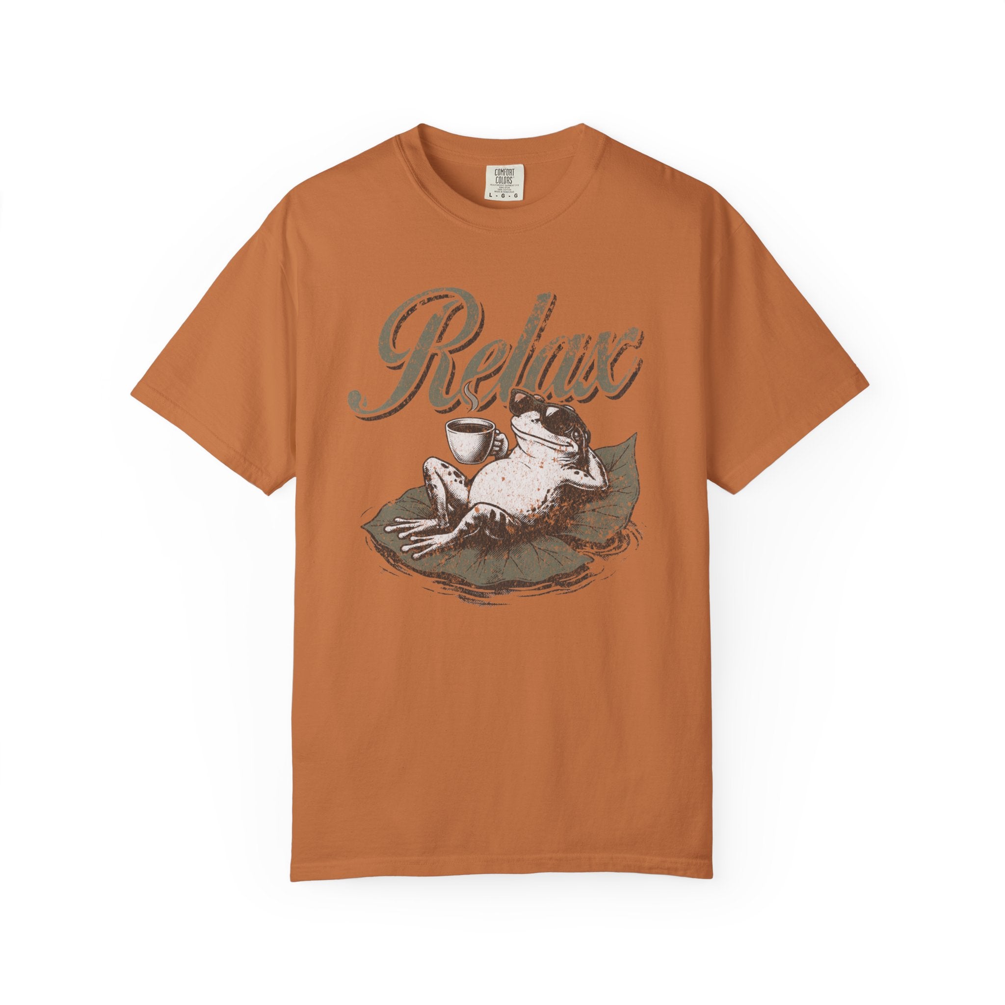 Unisex orange cotton t-shirt featuring a distressed graphic of a frog wearing sunglasses on a leaf.