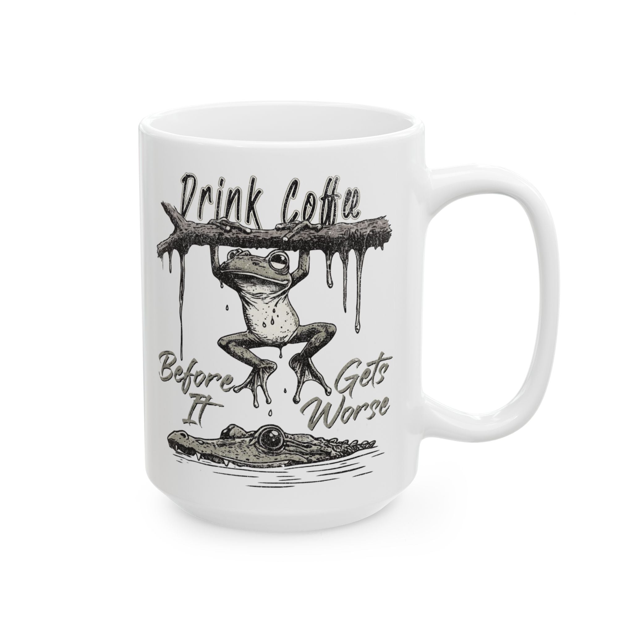 White ceramic mug featuring a frog hanging from a branch above a crocodile with coffee text.