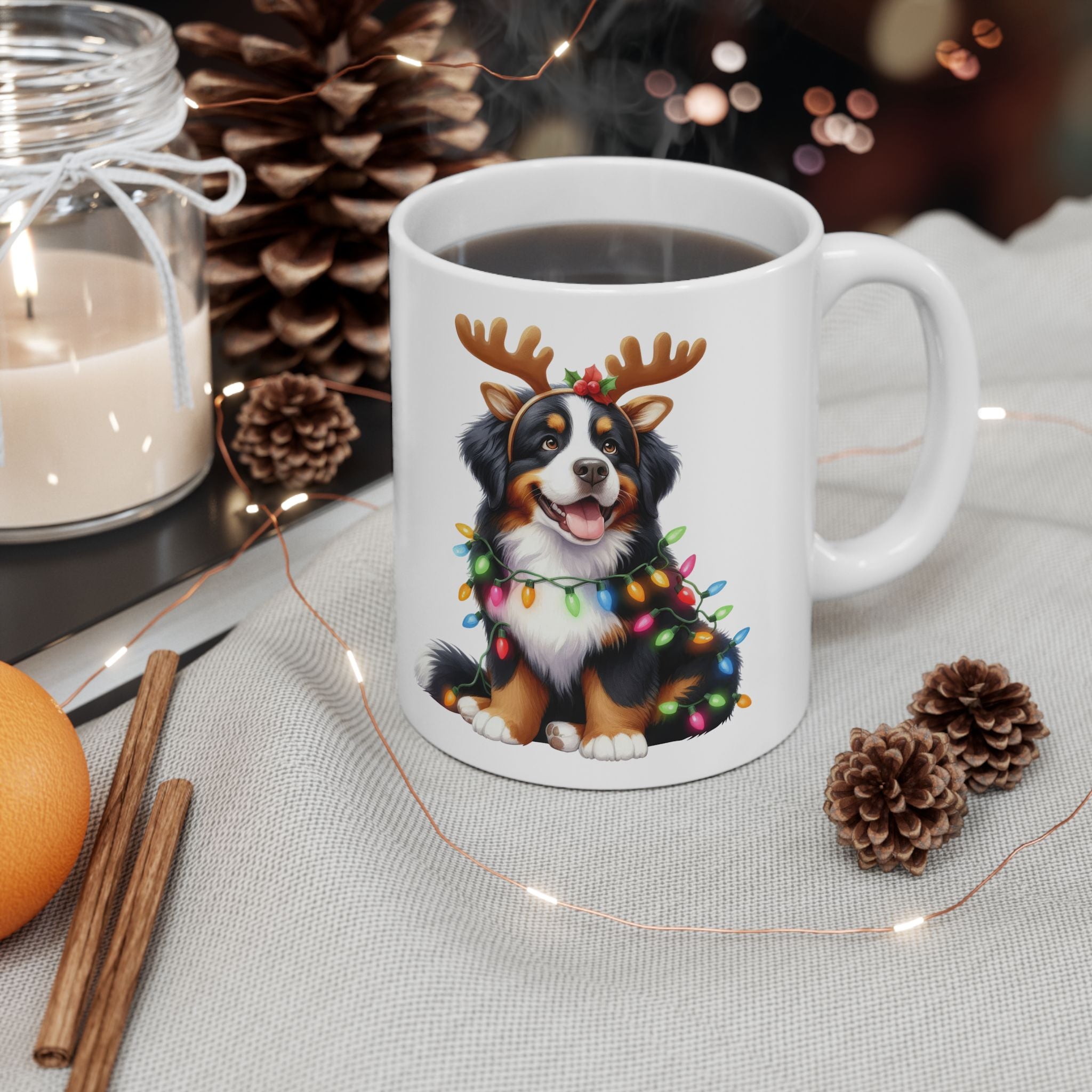 White ceramic mug with a Bernese Mountain Dog wearing reindeer antlers and Christmas lights.