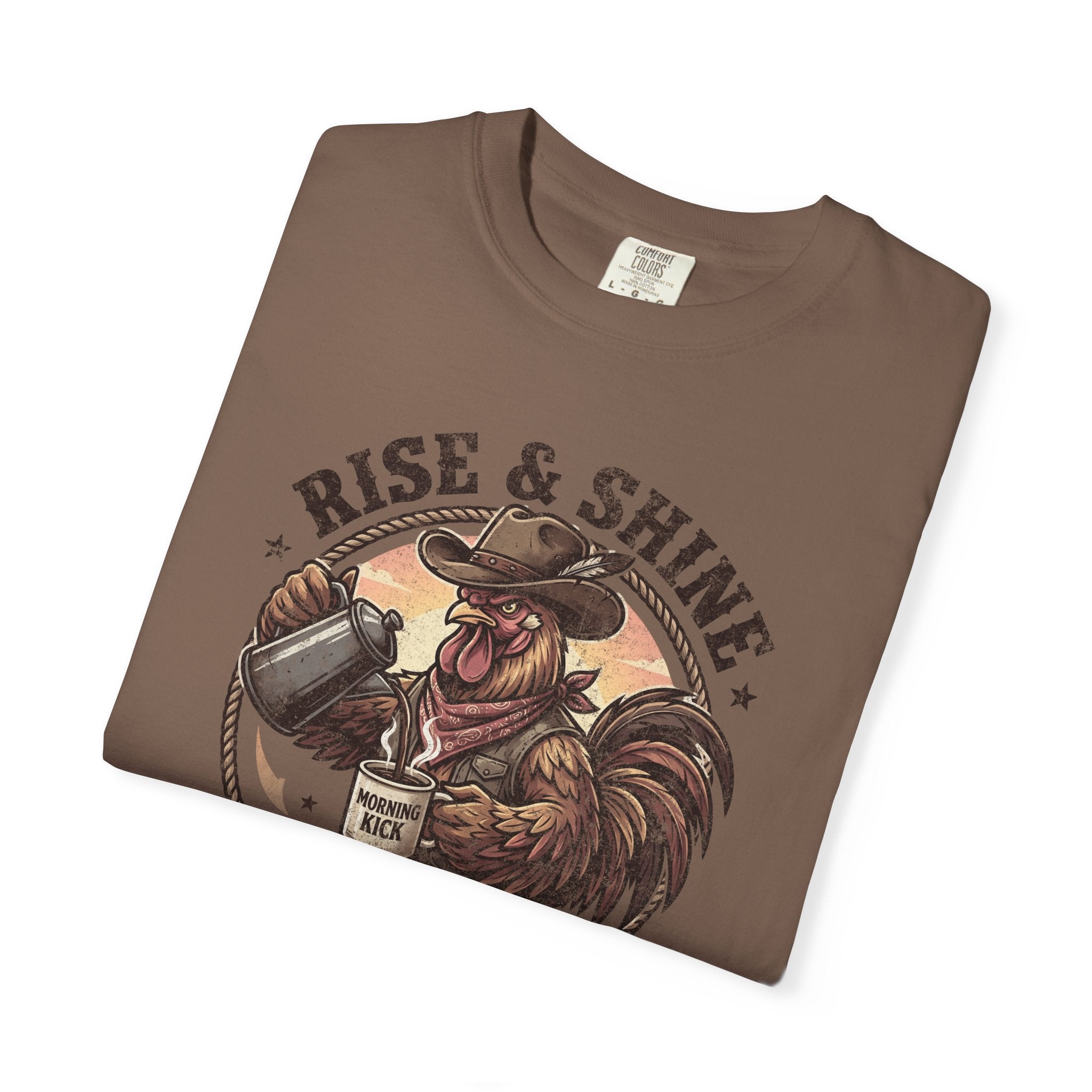 Brown graphic t-shirt featuring a cowboy rooster pouring coffee with the text Rise & Shine.