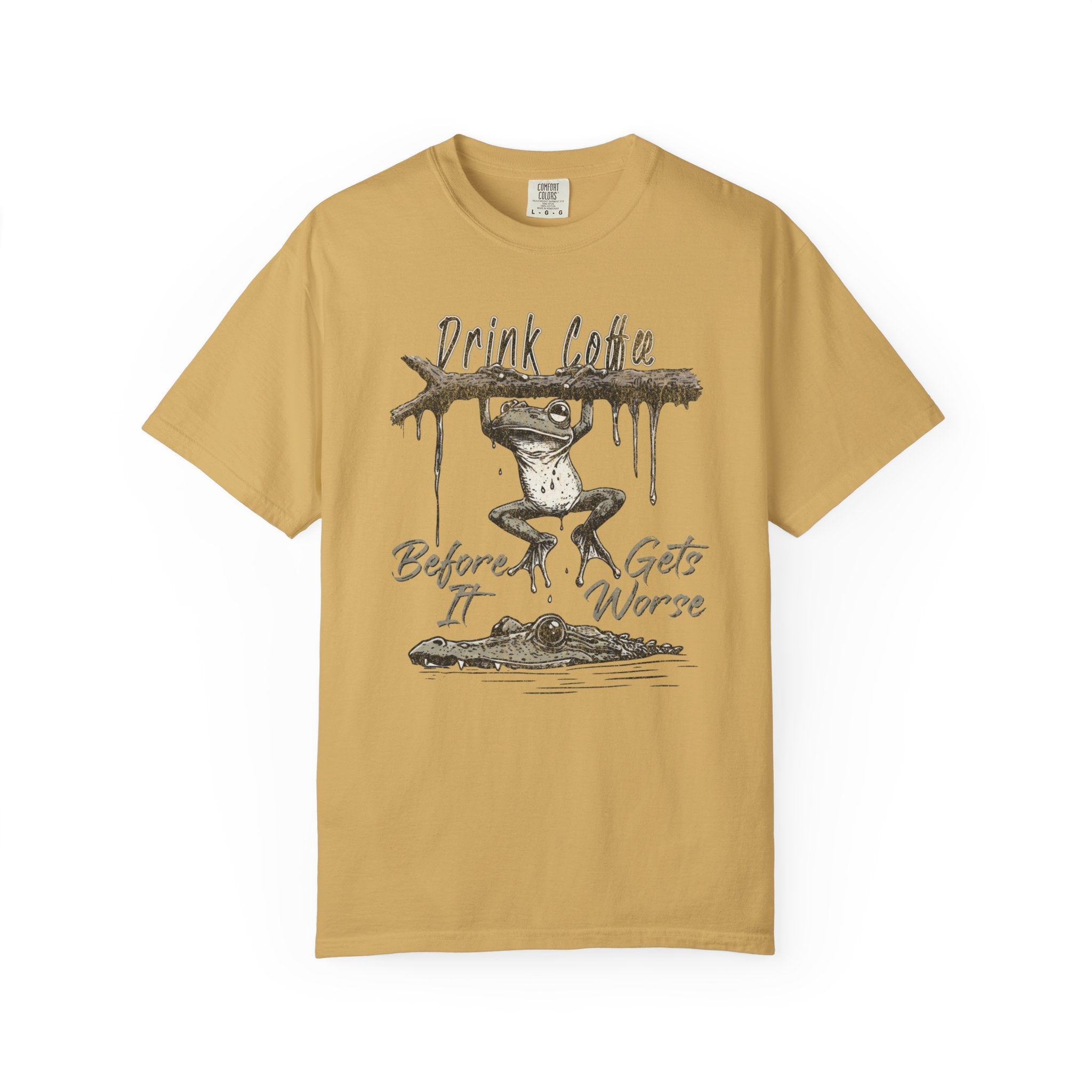 Mustard yellow unisex t-shirt with a graphic of a frog hanging from a branch above an alligator.