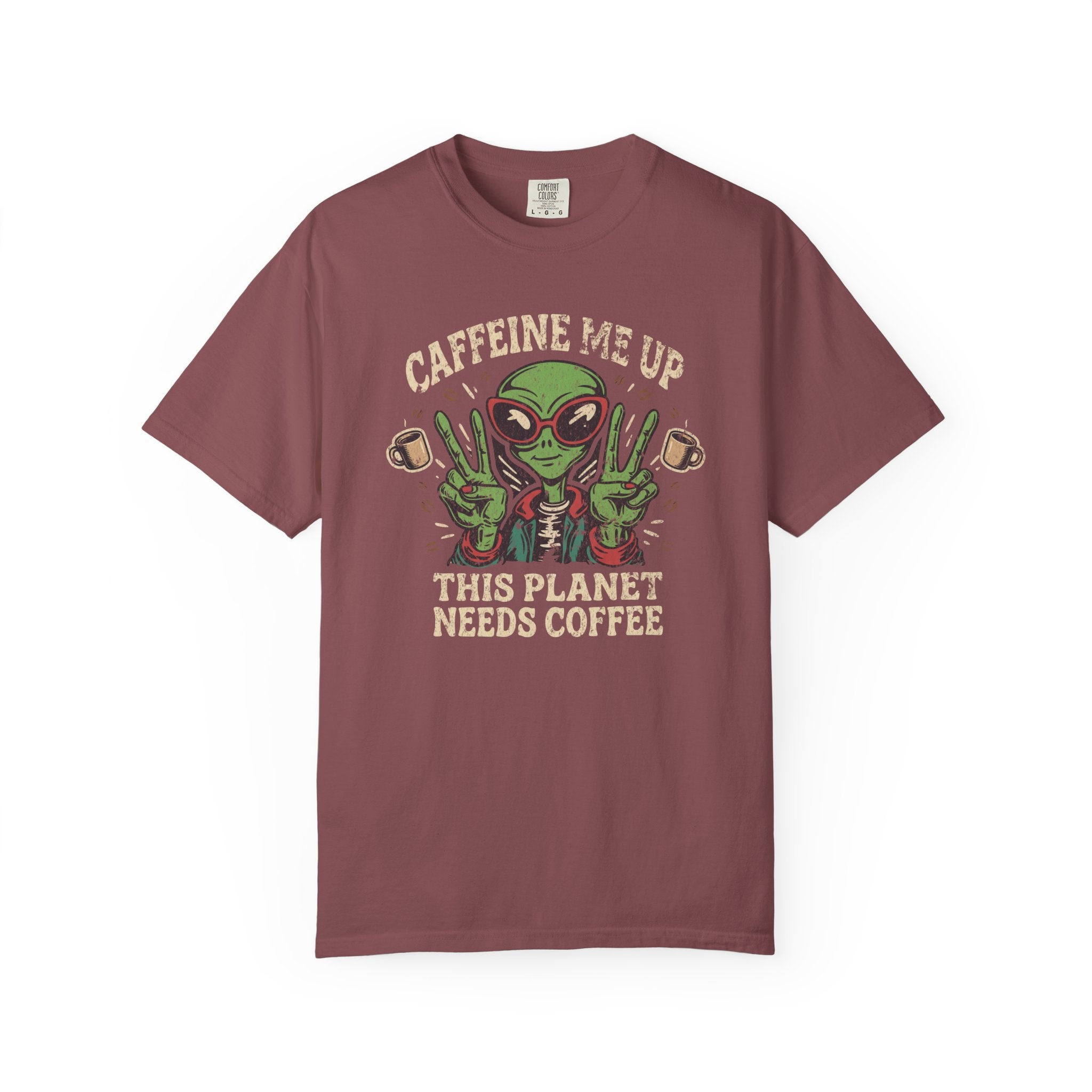 Maroon t-shirt featuring a green alien wearing sunglasses and making peace signs with coffee mugs.