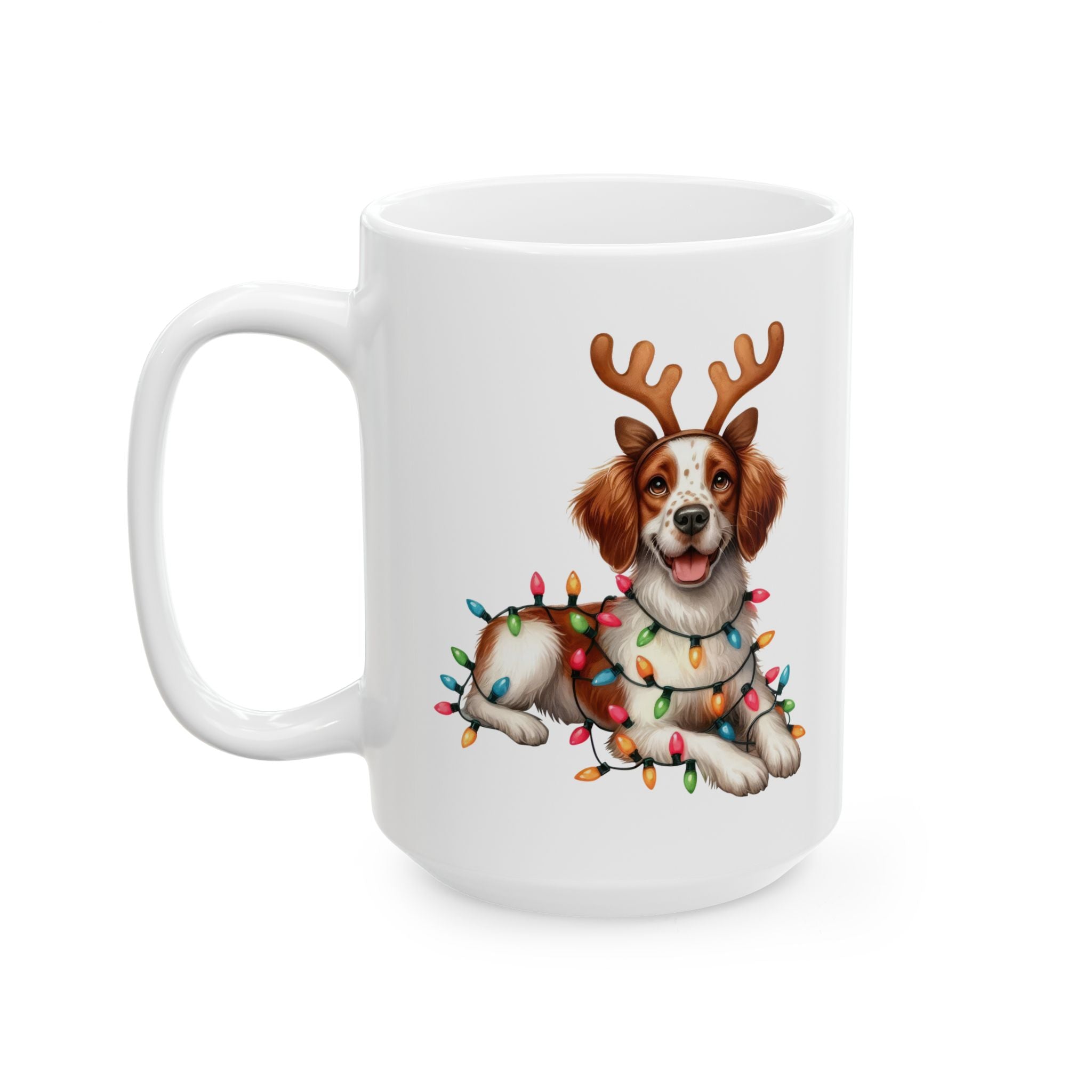 A white ceramic mug features a Brittany dog wearing reindeer antlers and Christmas lights.