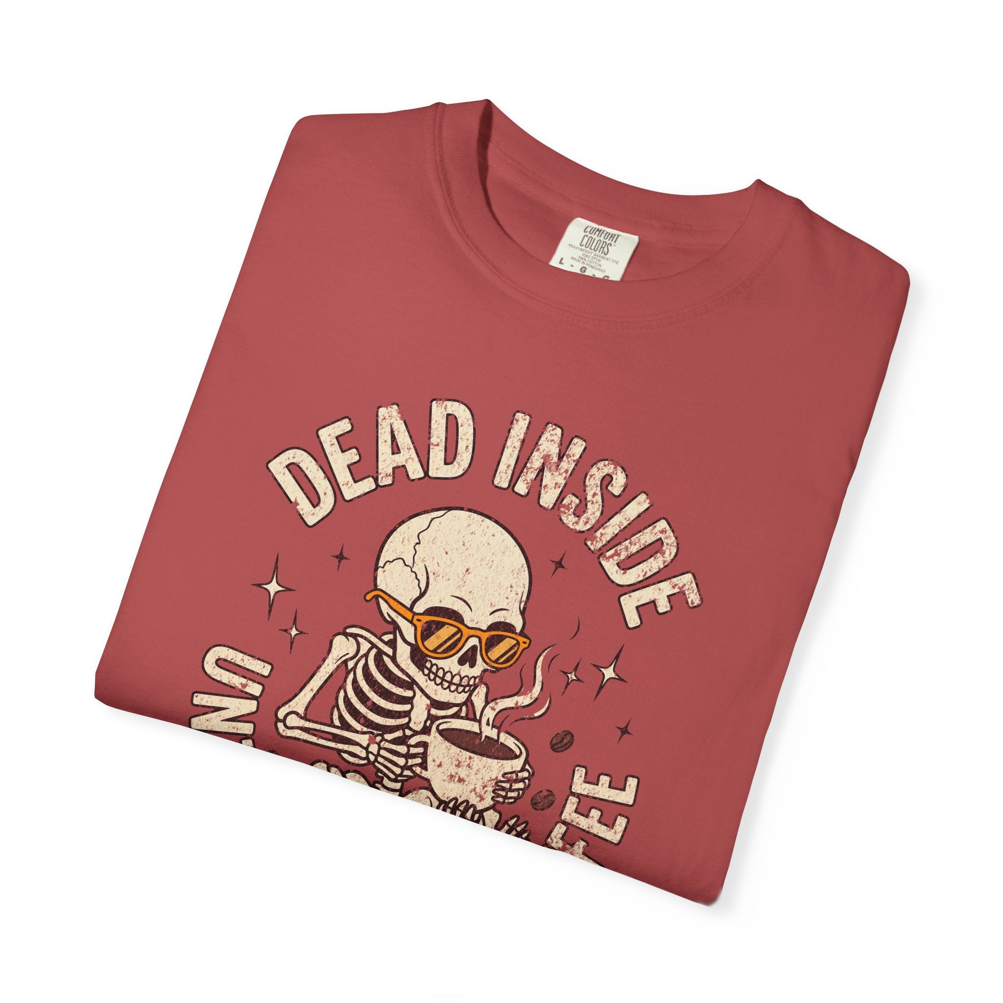 Red t-shirt with a distressed graphic of a skeleton wearing sunglasses and drinking coffee.