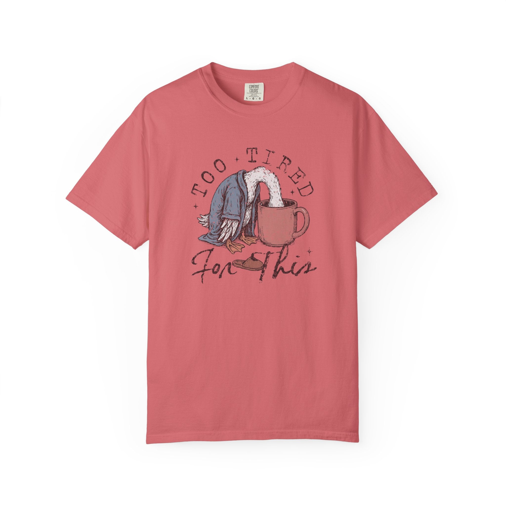 A coral-colored unisex t-shirt with a graphic of a duck with its head in a coffee mug.