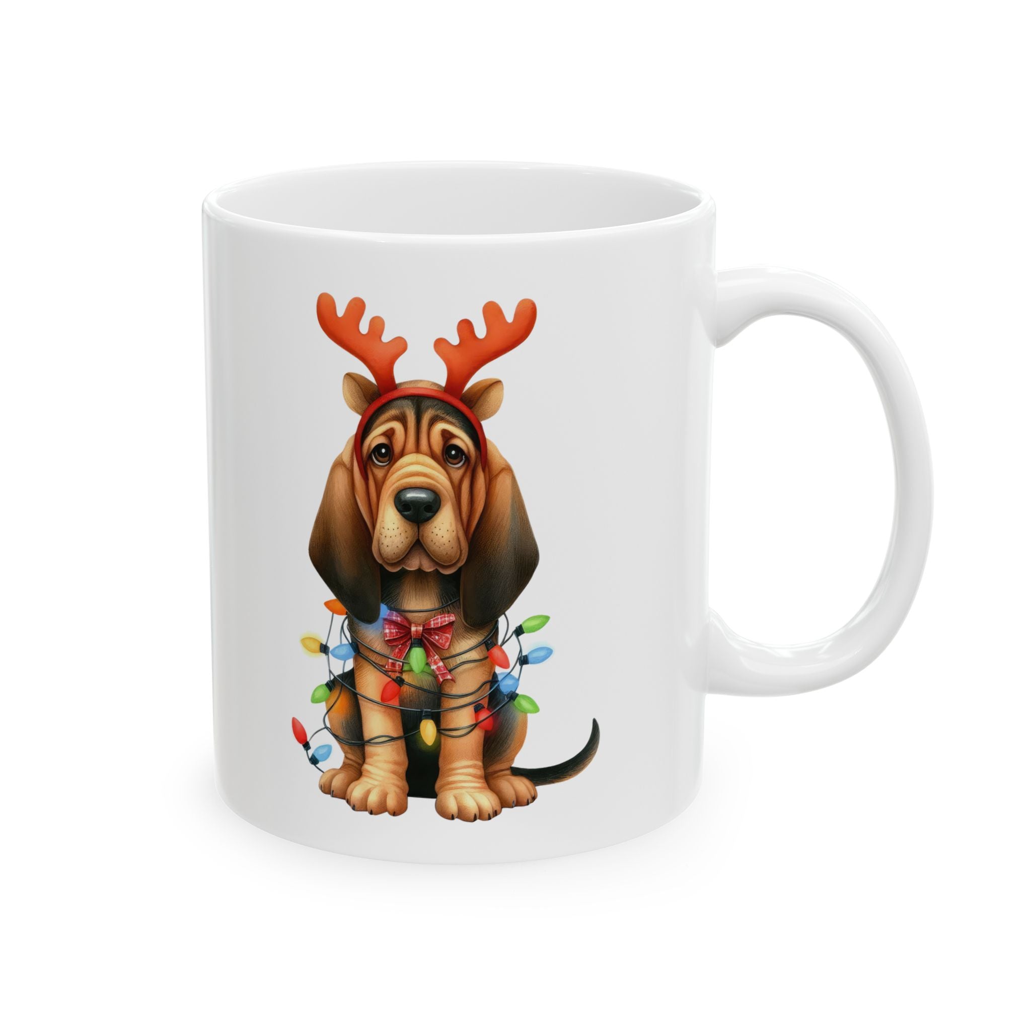 White ceramic mug featuring a bloodhound puppy wearing reindeer antlers and Christmas lights.