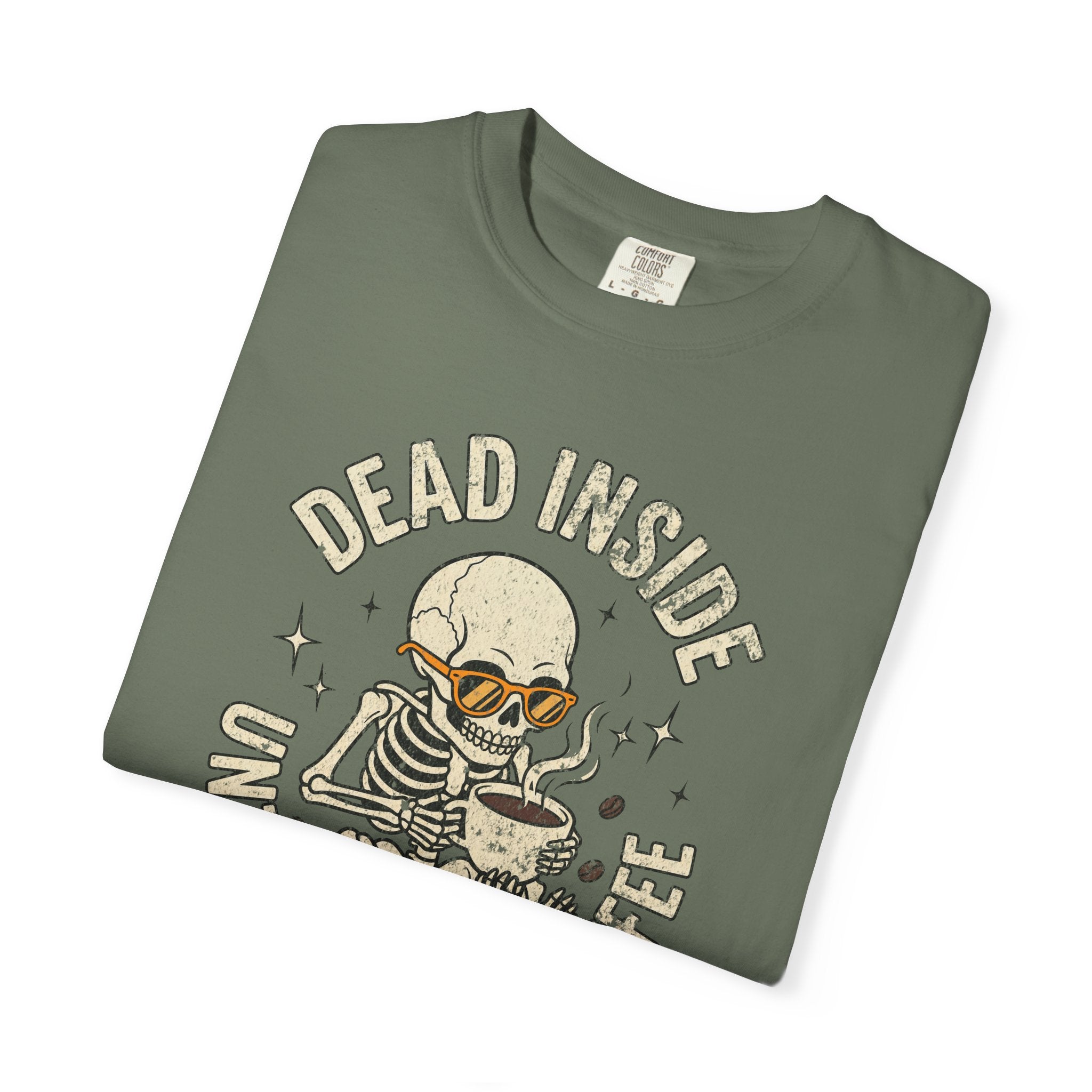 Olive green t-shirt with a distressed graphic of a skeleton wearing sunglasses drinking coffee.