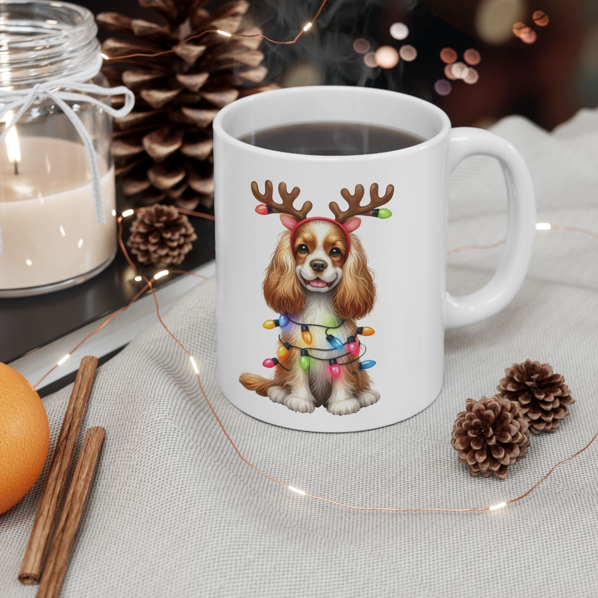 White ceramic mug with an American Cocker Spaniel wearing reindeer antlers and Christmas lights.
