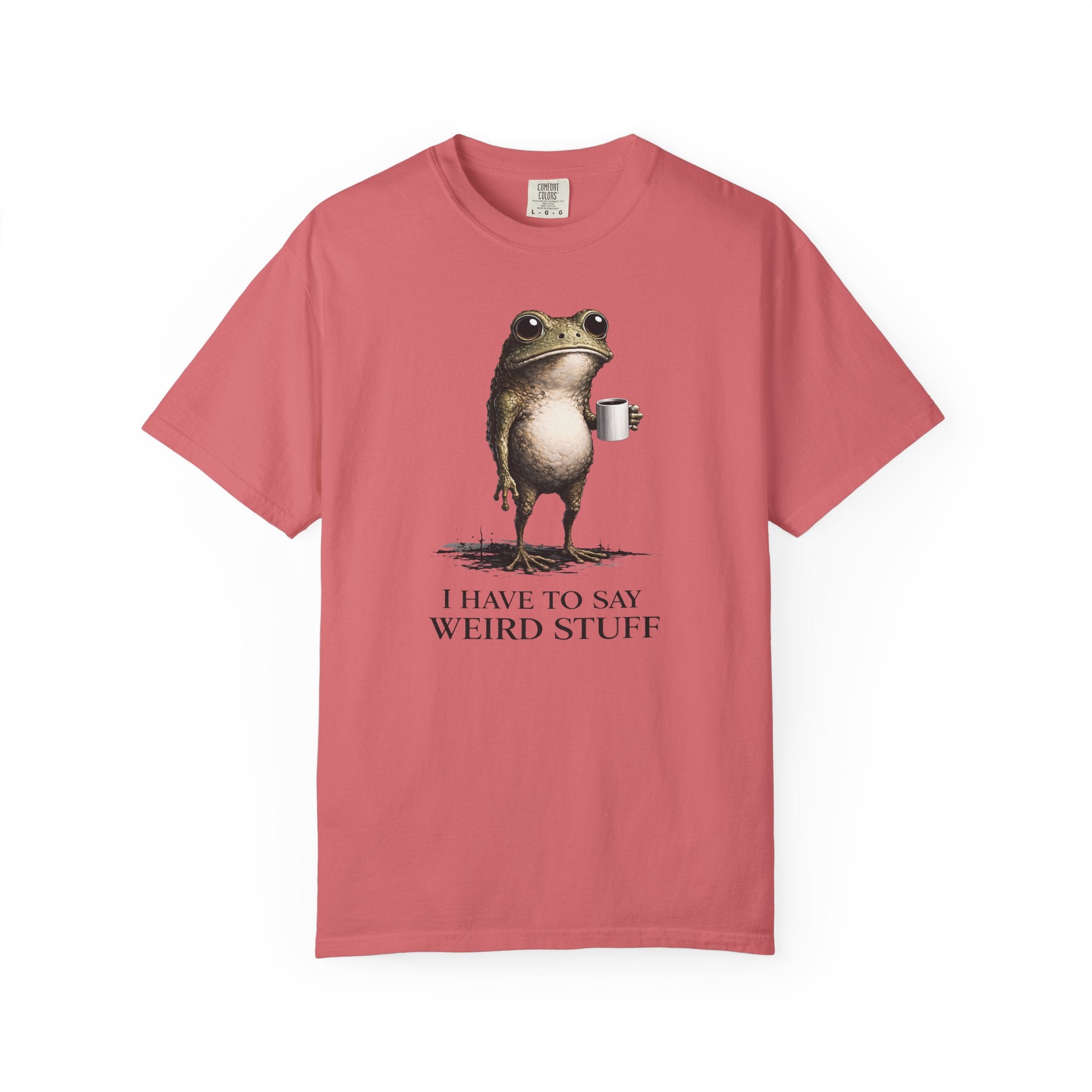 A dusty rose cotton t-shirt featuring a graphic of a frog holding a coffee mug with text below.