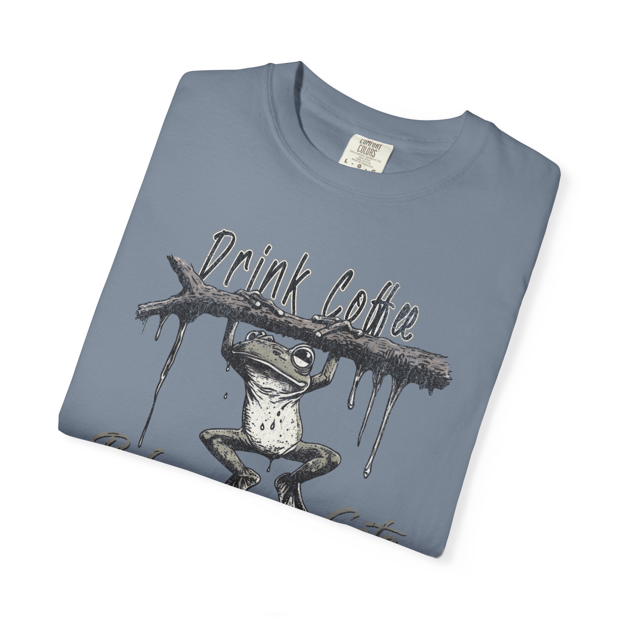 A blue-grey unisex cotton t-shirt featuring a graphic of a frog hanging from a branch.