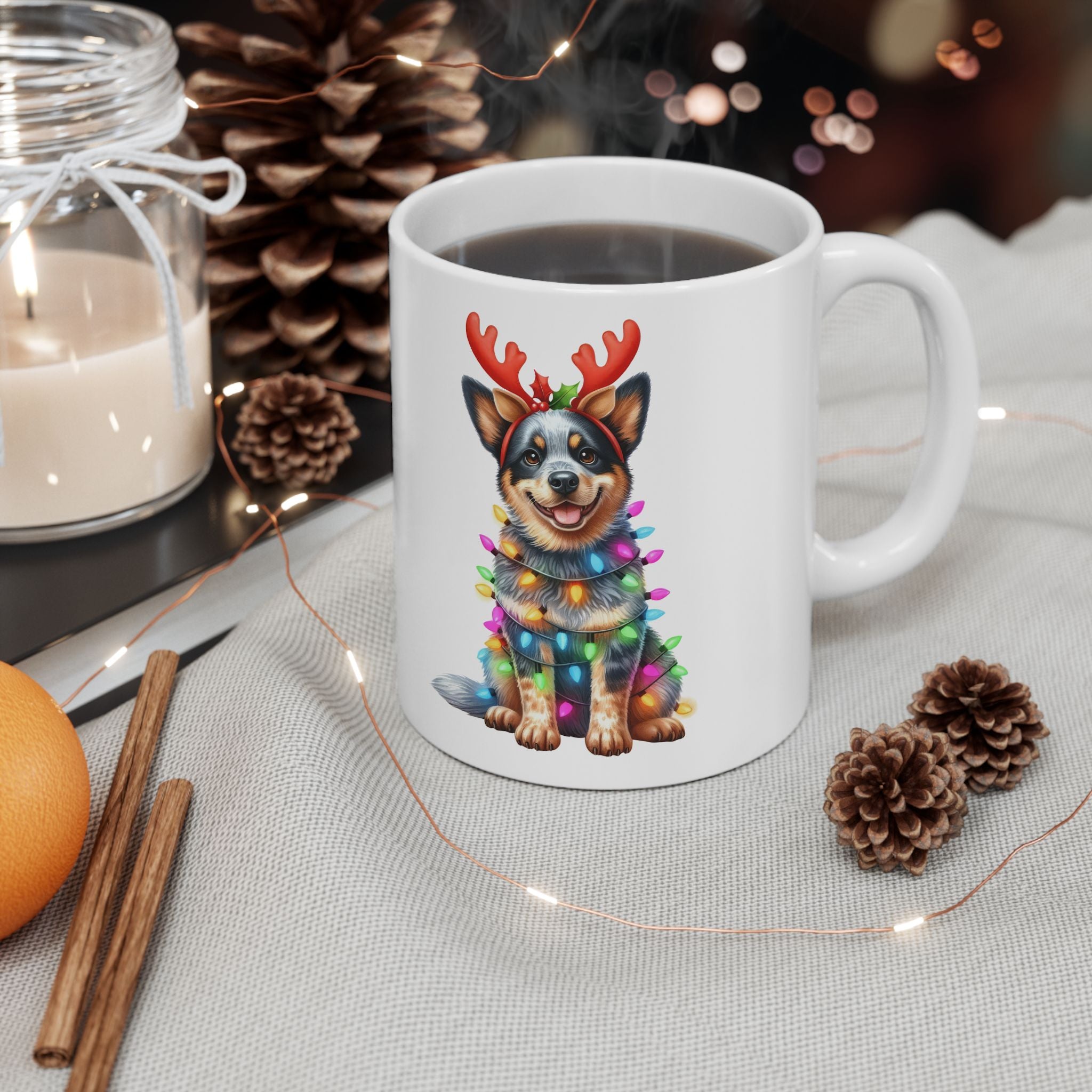 White ceramic mug with an Australian Cattle Dog wearing reindeer antlers and Christmas lights.