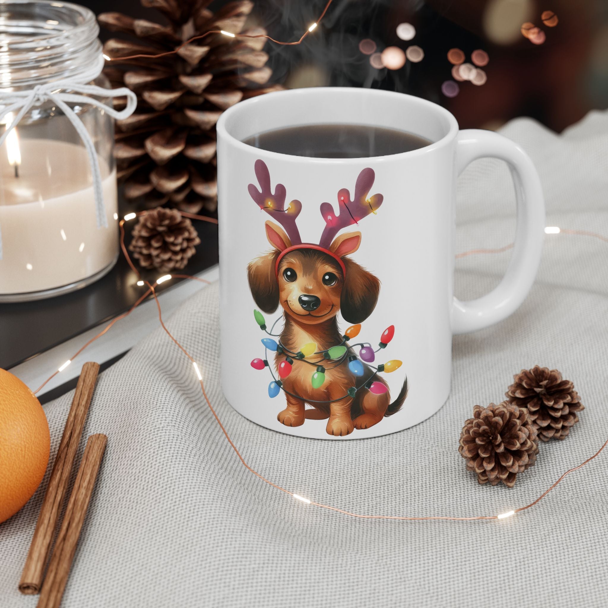 A white ceramic mug with a dachshund wearing reindeer antlers and Christmas lights.