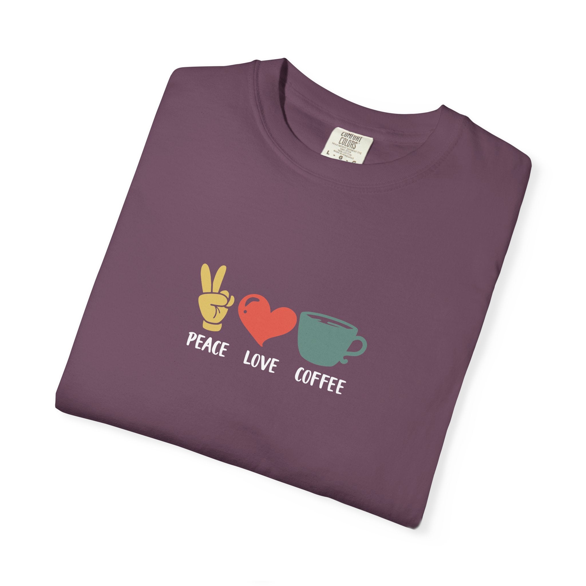 A folded dark purple heavyweight cotton t-shirt featuring a peace sign, heart, and coffee cup icon.