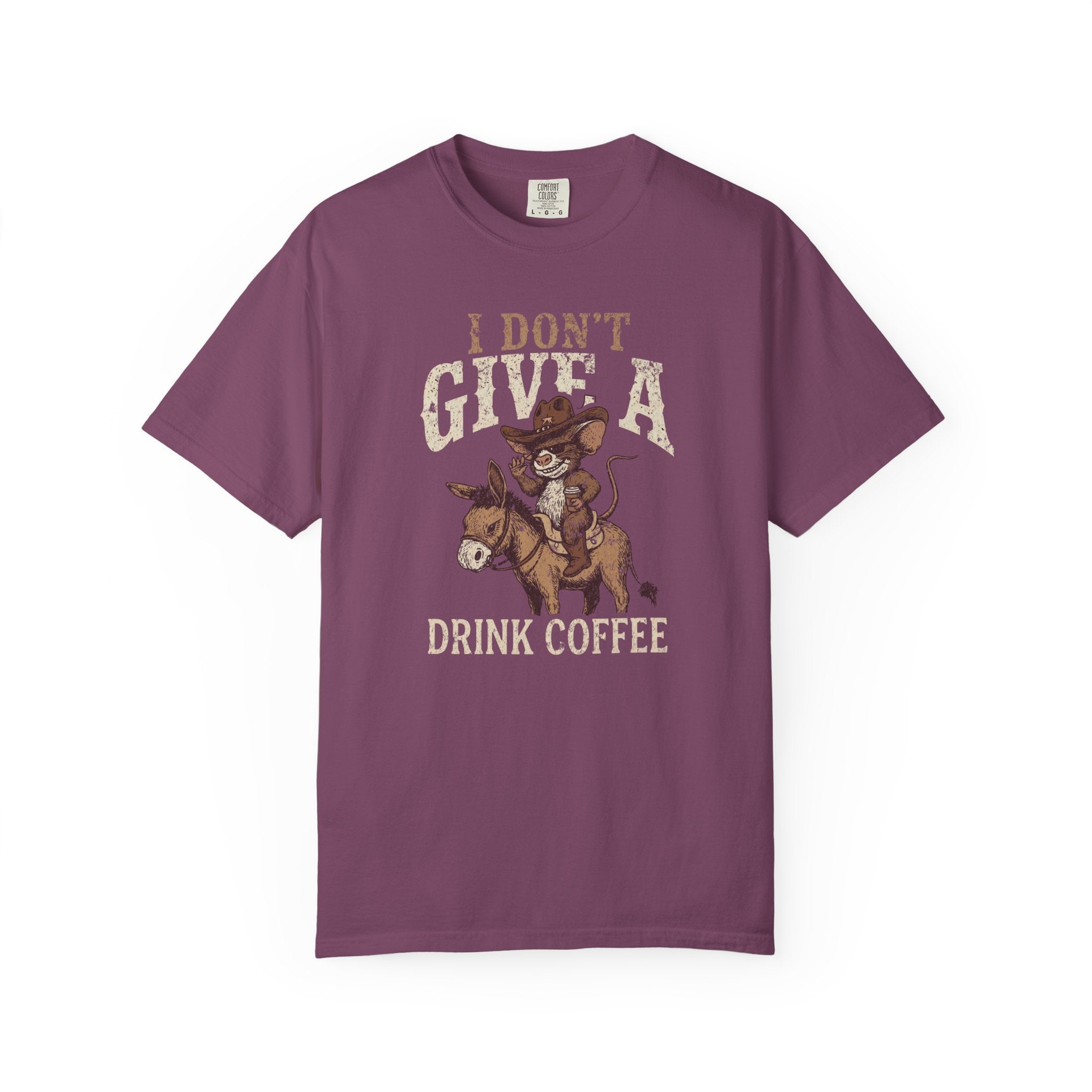 Purple unisex t-shirt with a distressed graphic of a cowboy rat riding a donkey, drinking coffee.