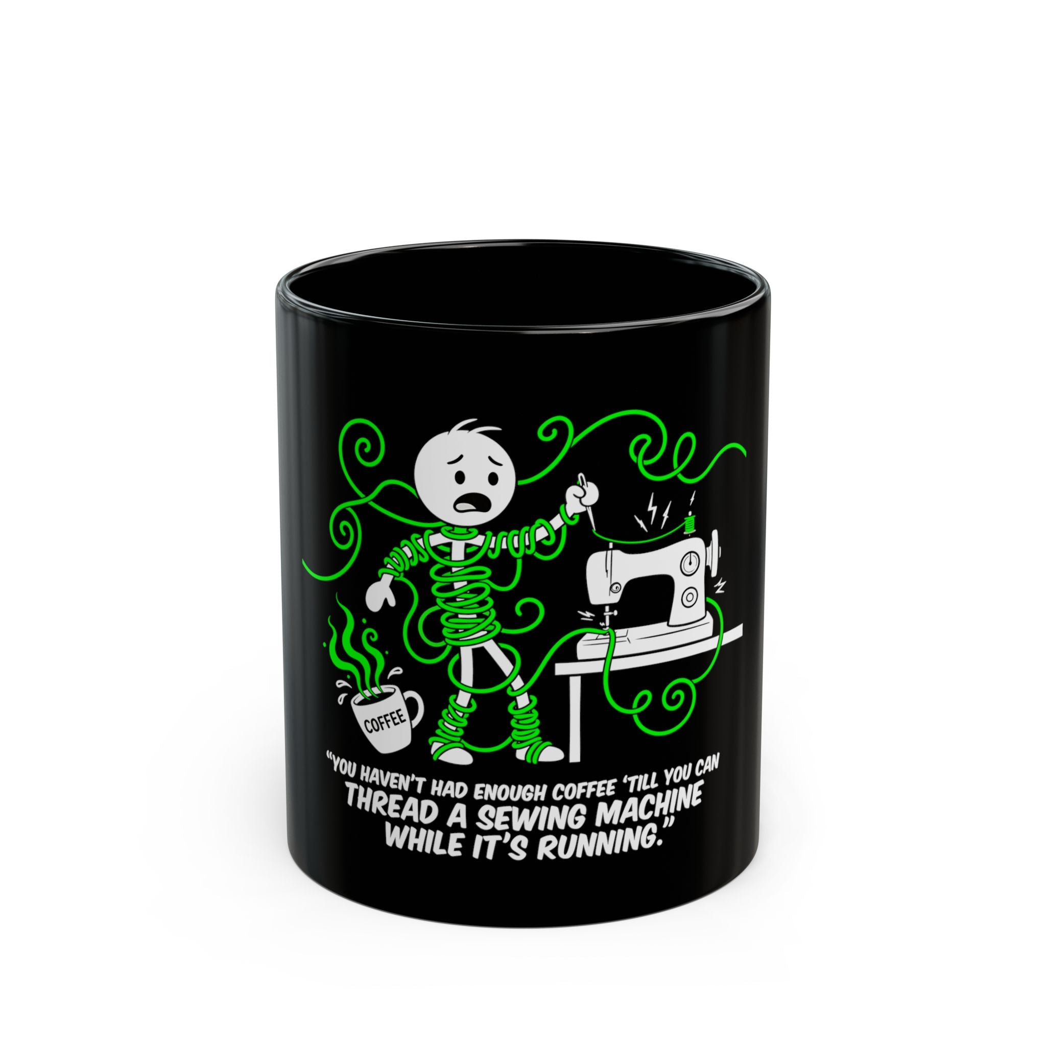 Black ceramic mug featuring a stick figure tangled in green thread next to a sewing machine.