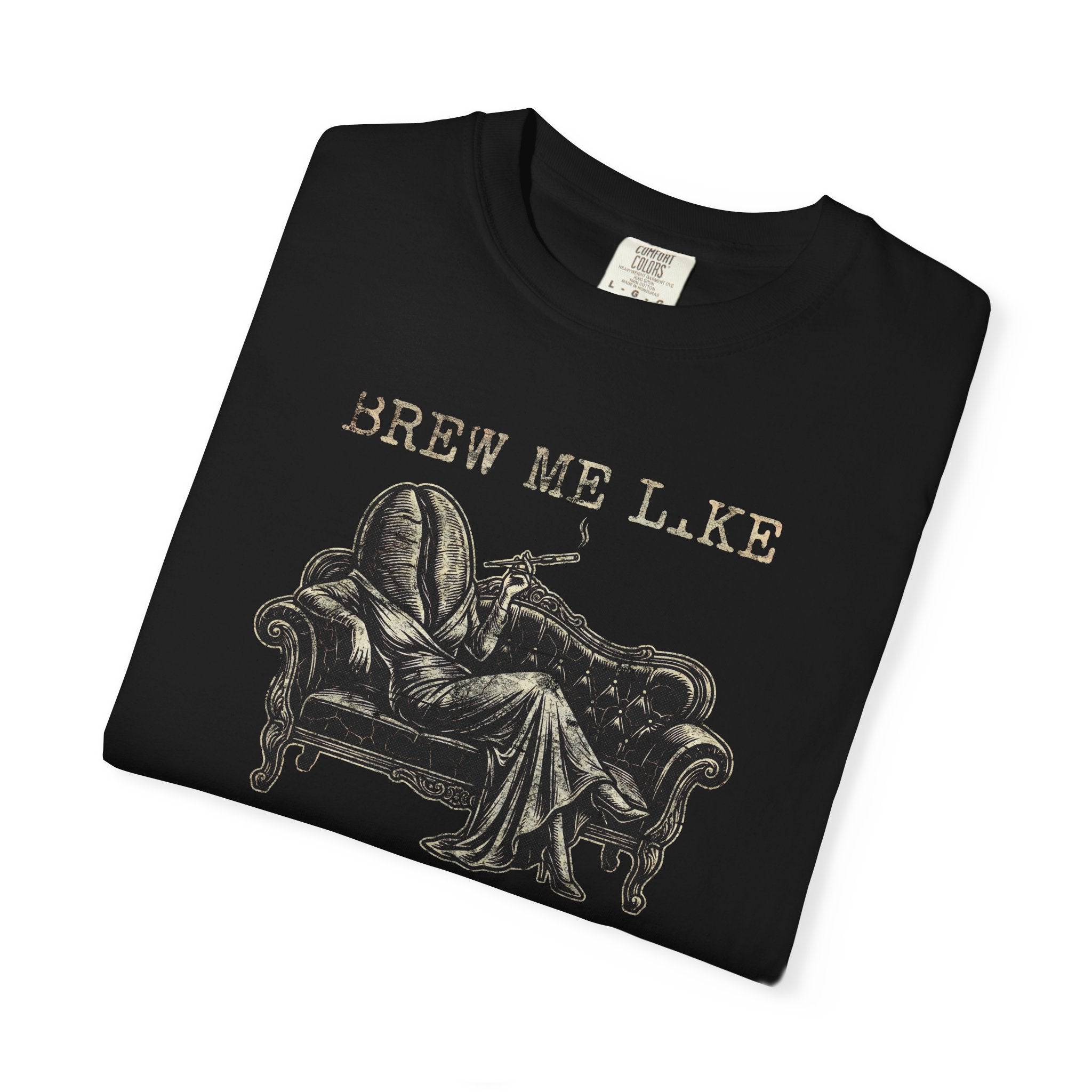 Black Comfort Colors 1717 t-shirt with a vintage-style graphic of a coffee bean person on a sofa.