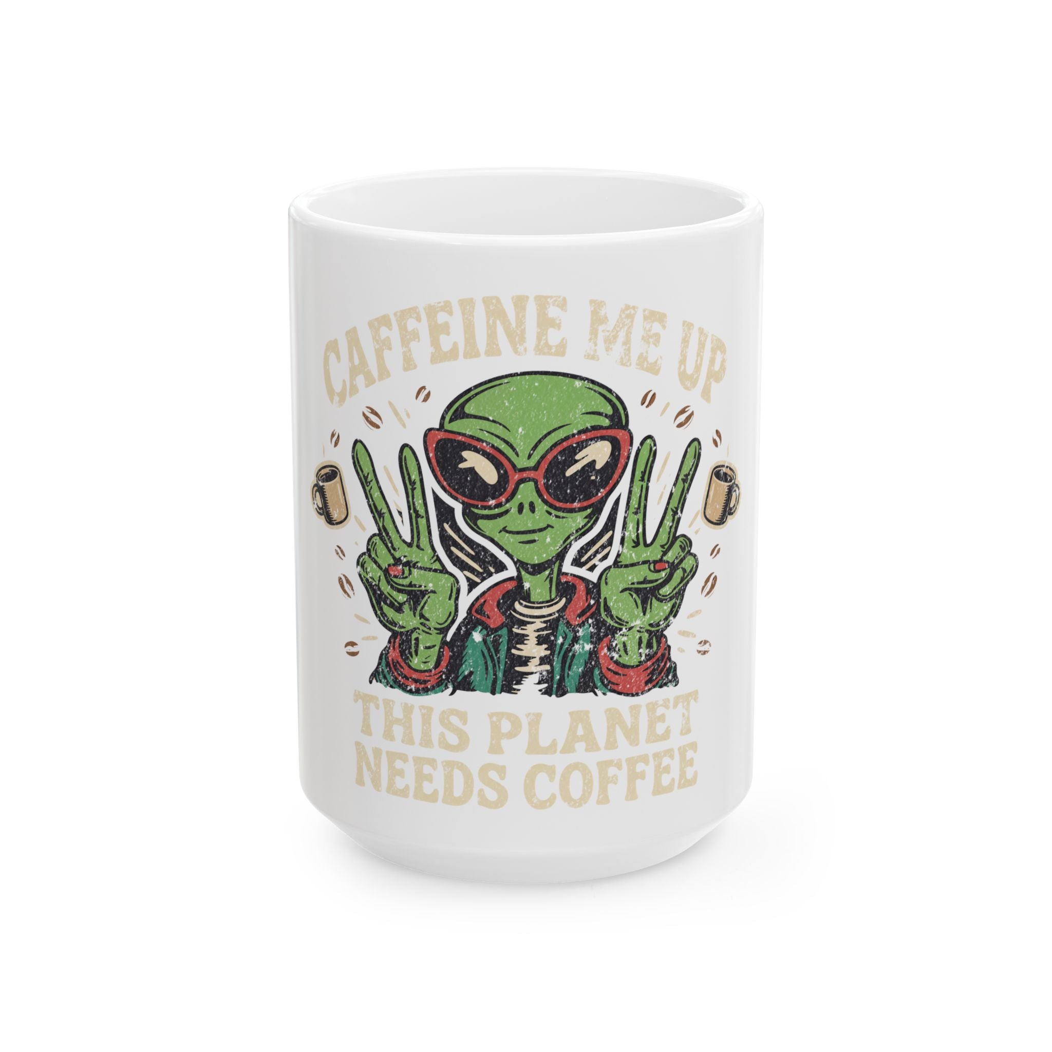 White ceramic mug featuring a green alien wearing sunglasses and making peace signs with coffee.