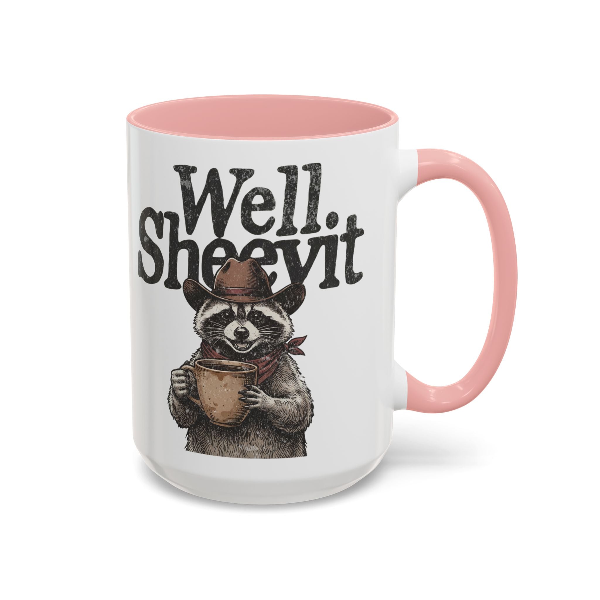 A white ceramic mug with a pink handle and rim, featuring a raccoon wearing a cowboy hat and scarf.