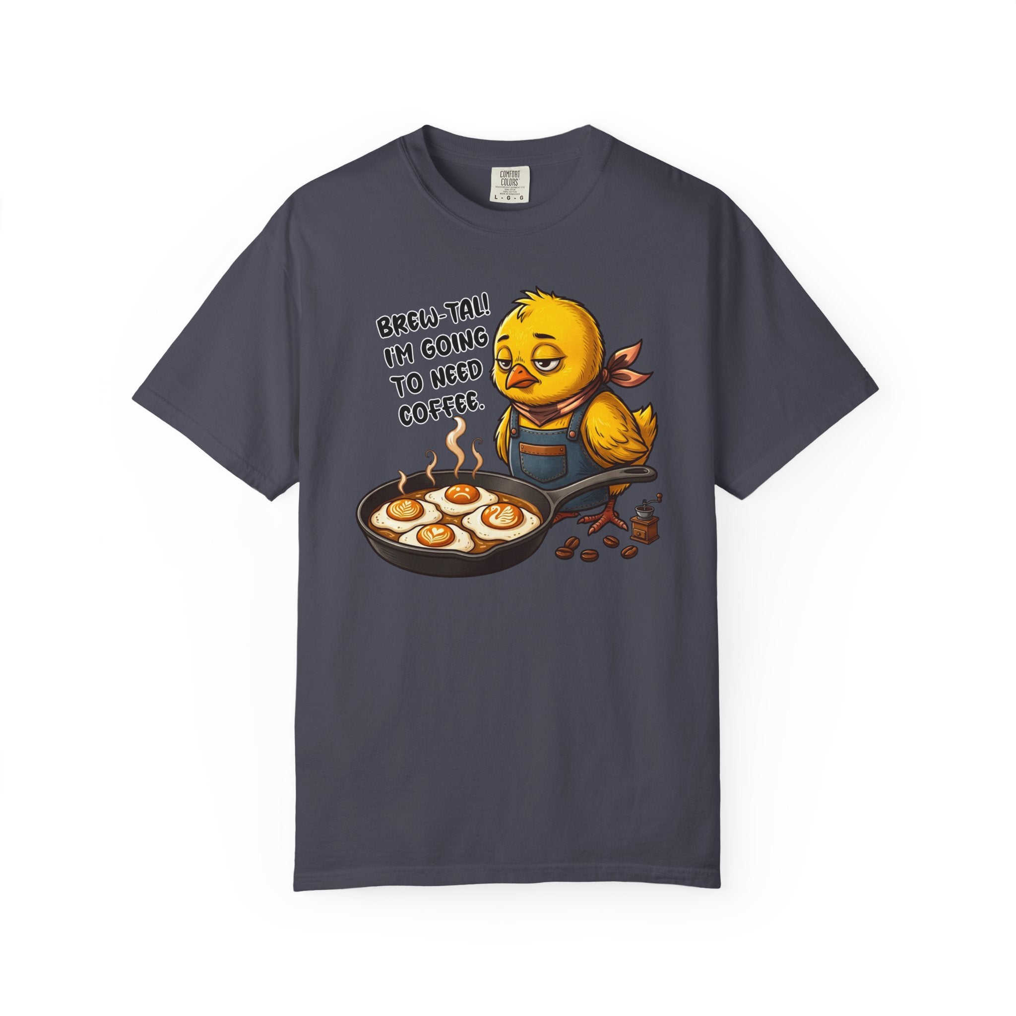 Dark grey t-shirt featuring a sleepy chick in an apron with a frying pan of coffee-art eggs.