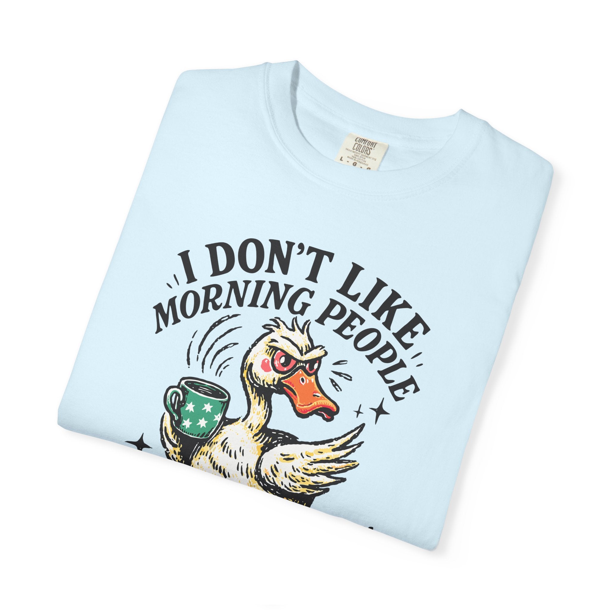Light blue t-shirt featuring a grumpy duck holding a coffee mug with the text I DON'T LIKE MORNING