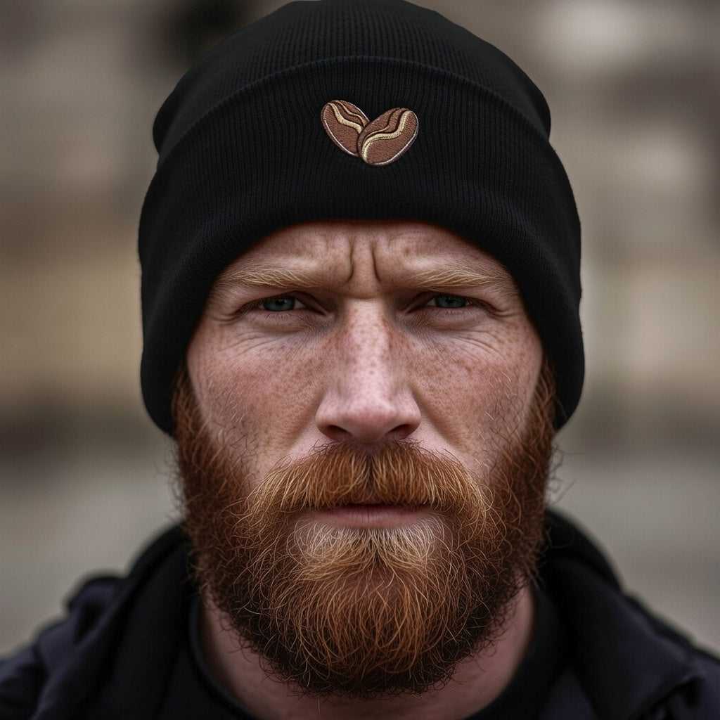 Black cuffed beanie with embroidered coffee bean heart detail.