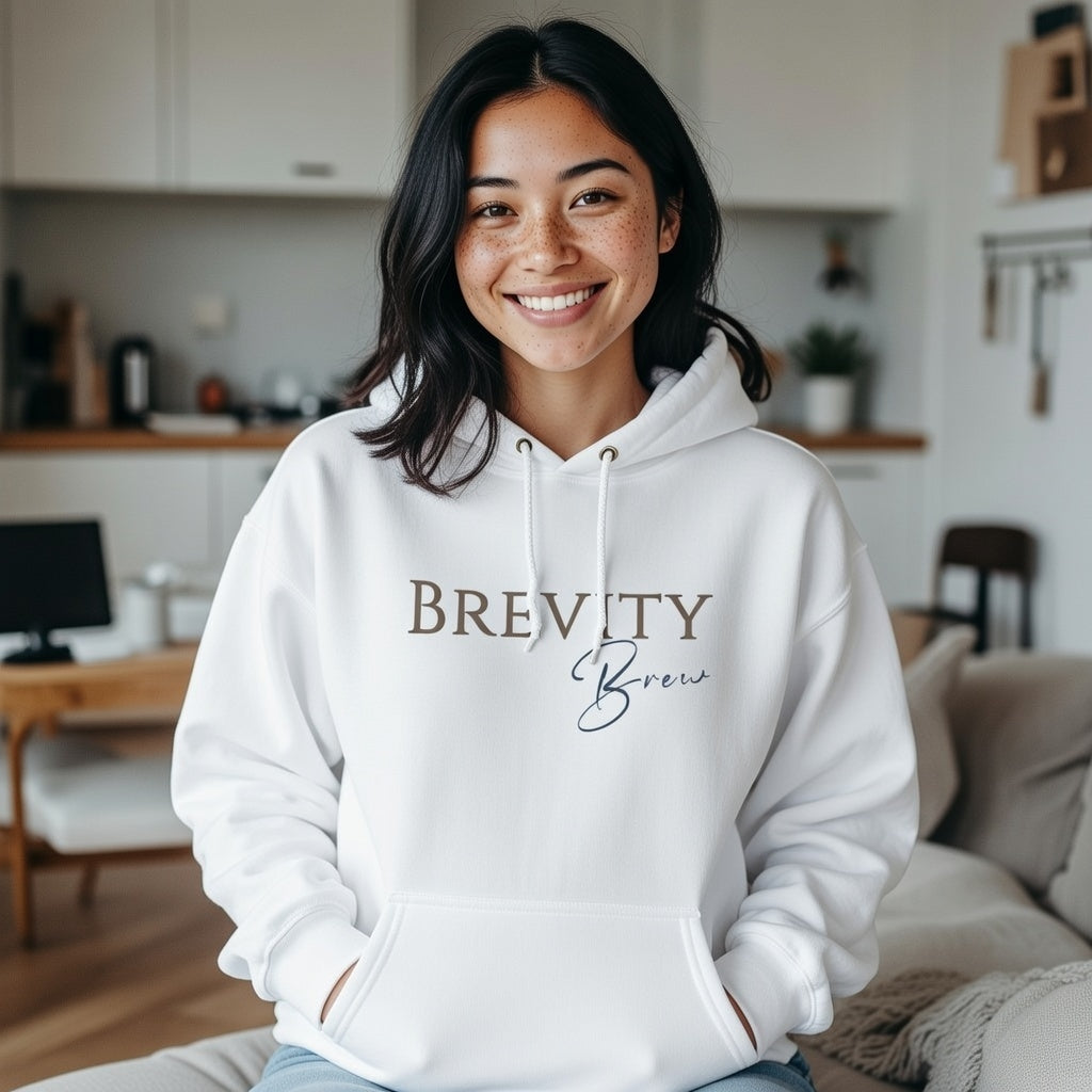 A woman smiles in a white Brevity Brew minimalist script logo hoodie with a front pocket.