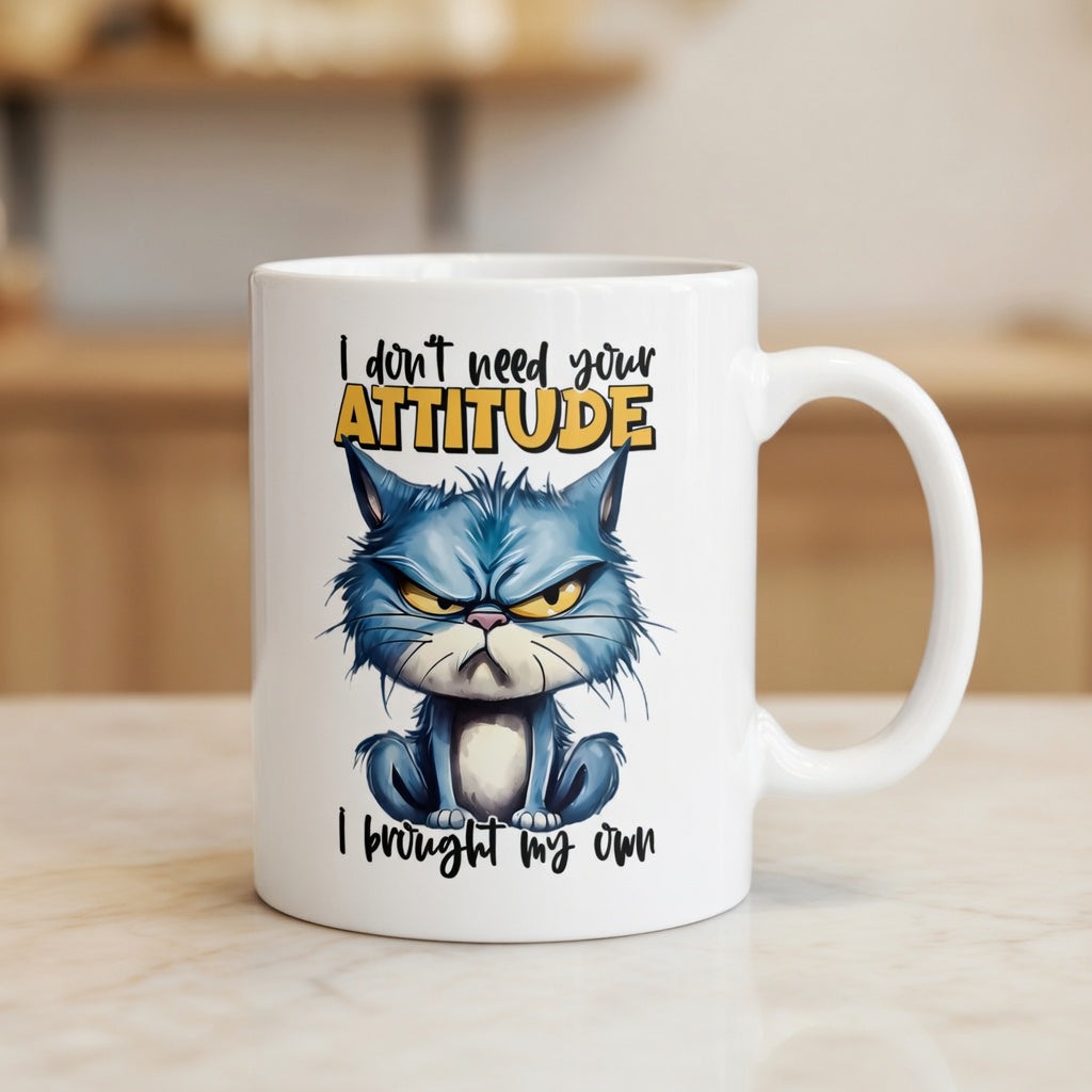 White ceramic mug featuring a grumpy blue cat and the text I don't need your attitude I brought my own.