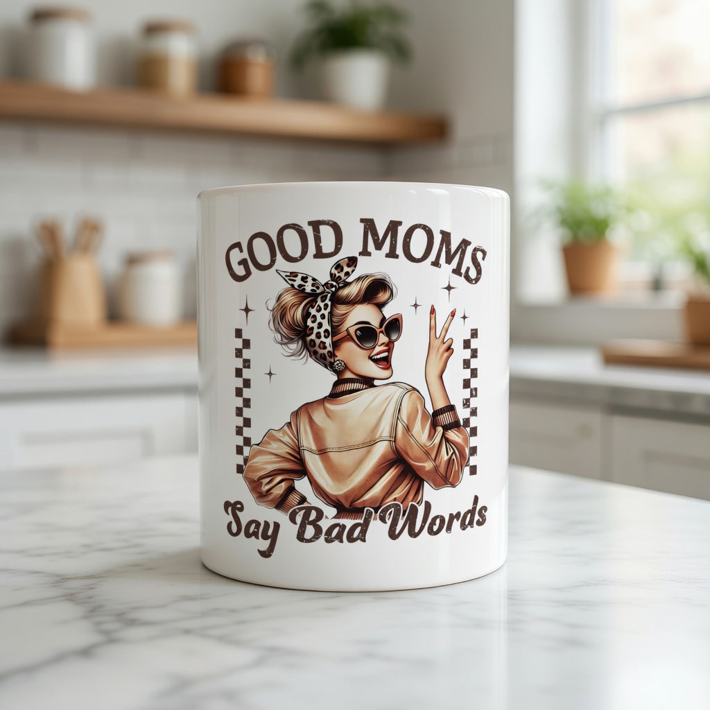 White ceramic mug featuring a retro-style woman and the text Good Moms Say Bad Words.