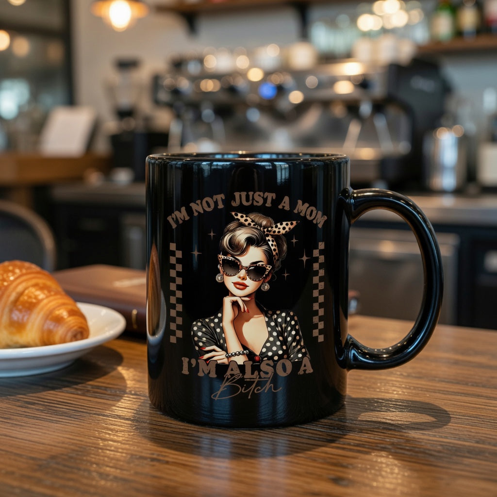 Black ceramic mug featuring a retro pin-up woman and text reading I’m Not Just a Mom, I’m Also a Bitch