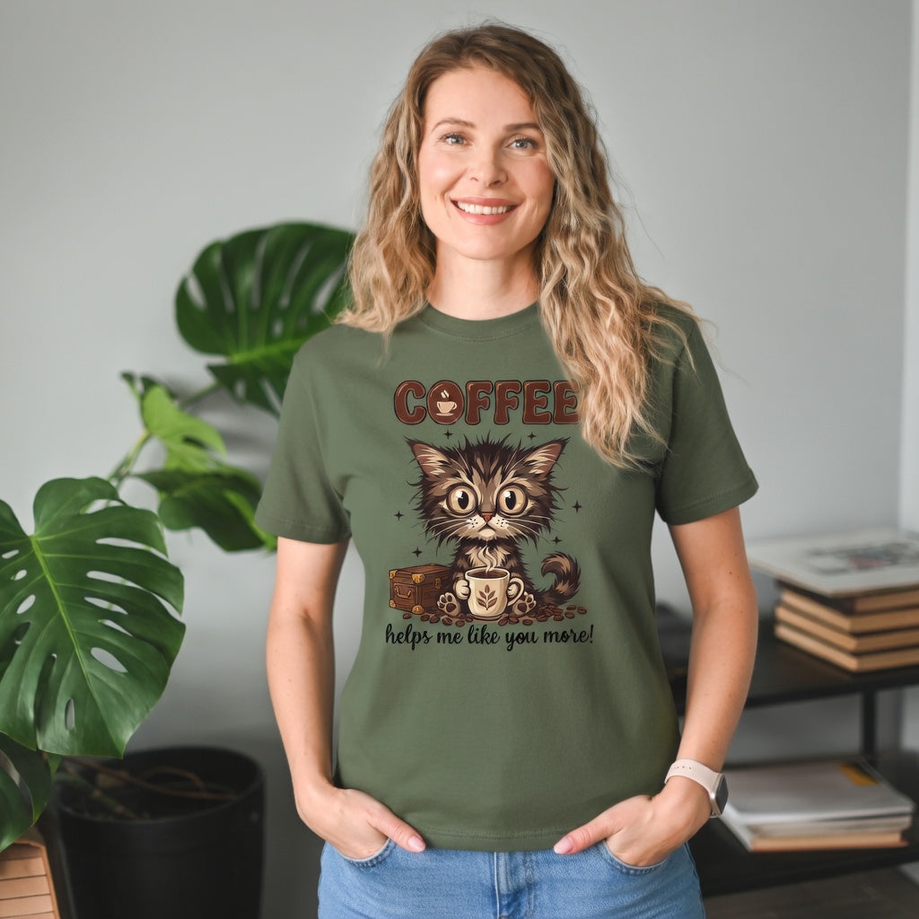 A woman wearing an olive green t-shirt with a cartoon kitten graphic and coffee-themed text.