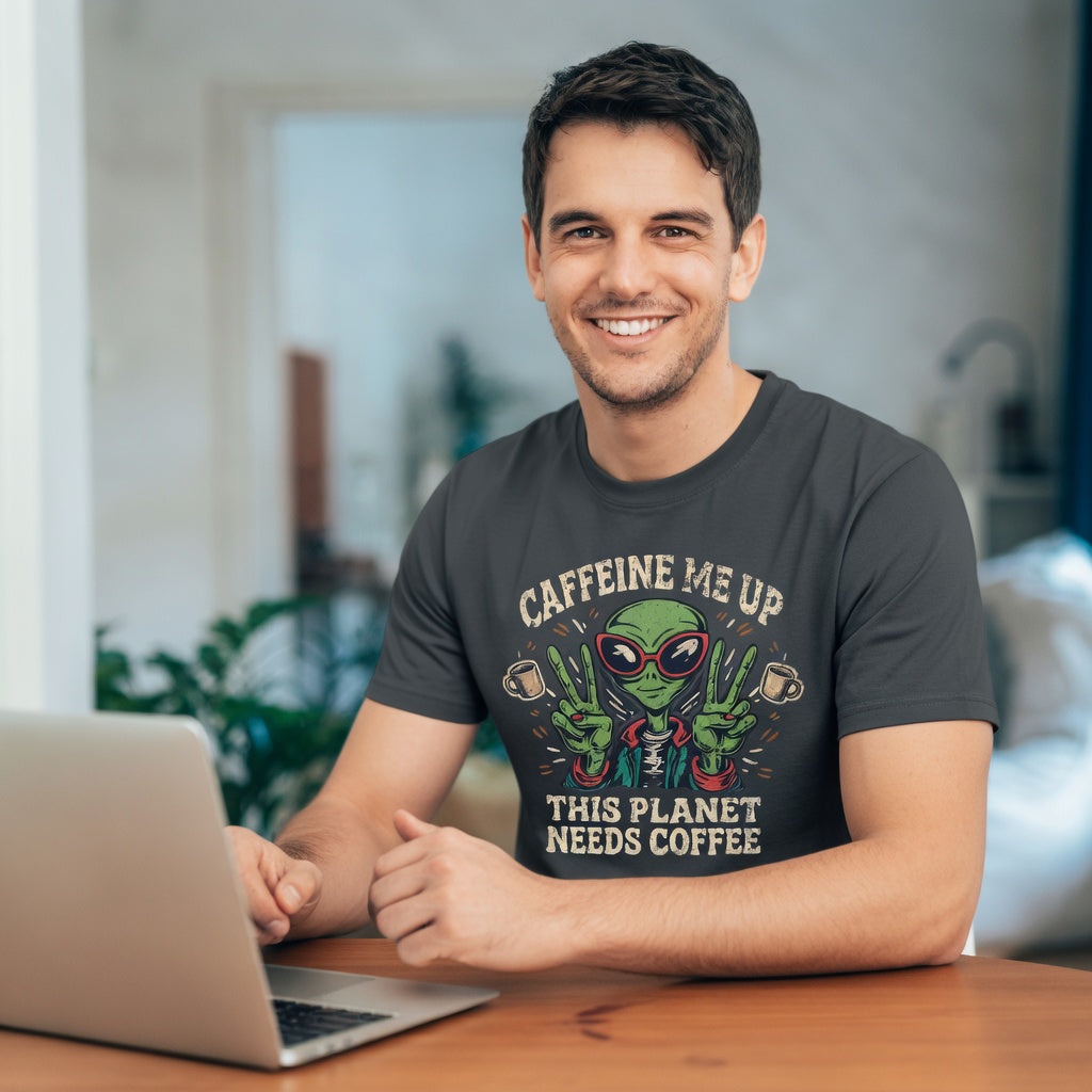 A man wearing a charcoal grey t-shirt with a distressed alien graphic and coffee-themed text.