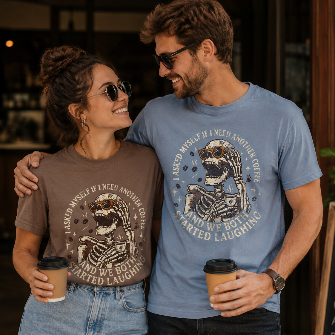A man and woman wearing Skeleton Coffee Tees with a distressed graphic and dark humor quote.