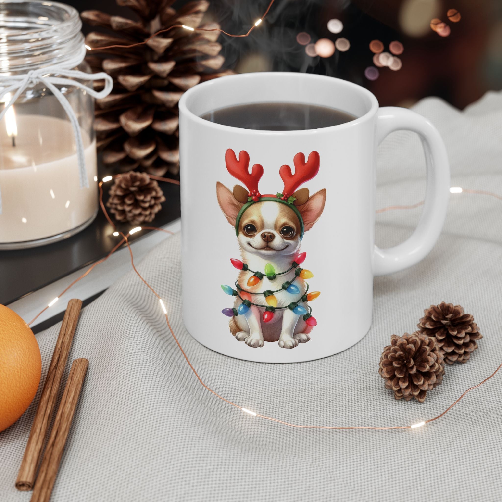 A white ceramic mug with a festive chihuahua design sits on a light grey tablecloth.