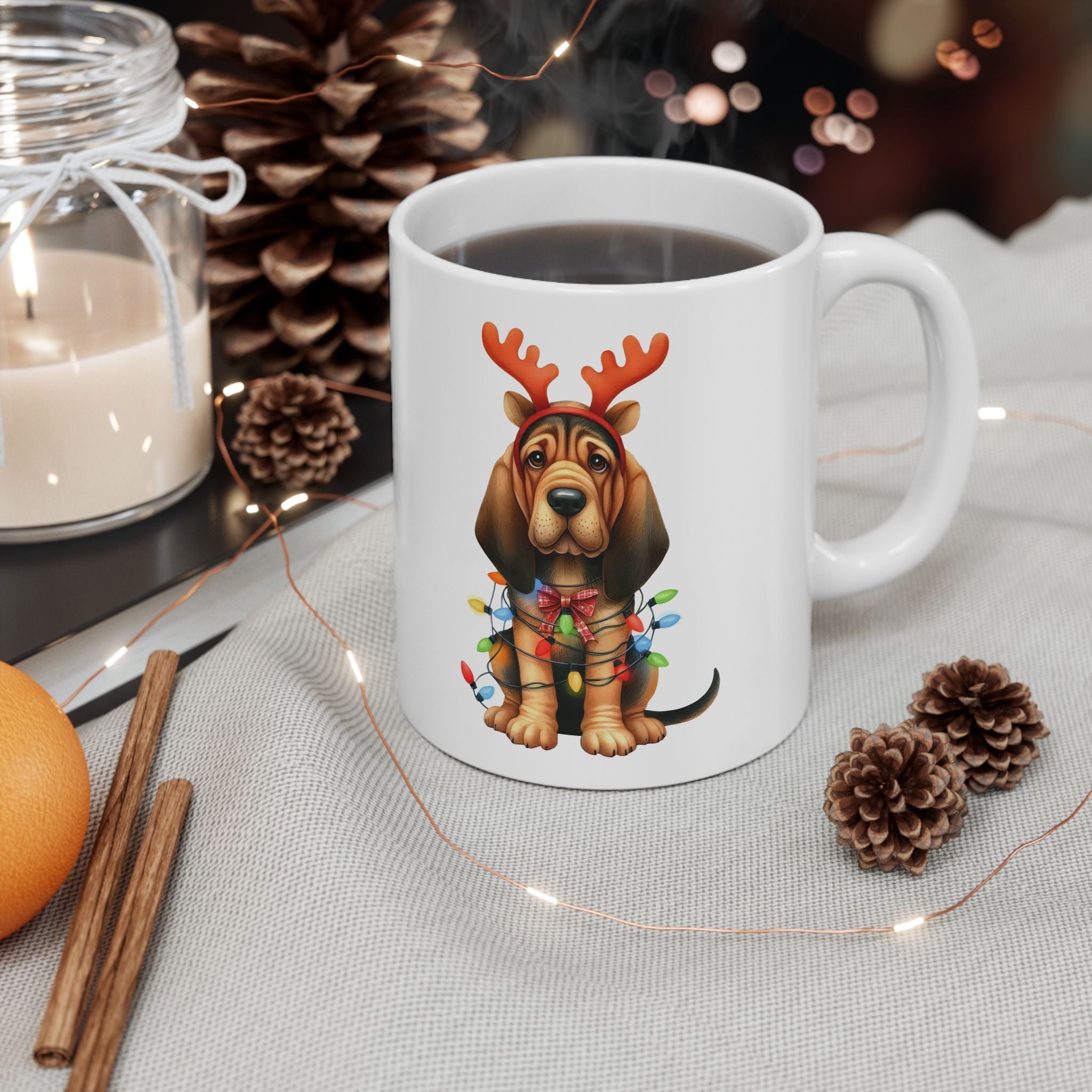 A white ceramic mug with a bloodhound wearing reindeer antlers and Christmas lights.