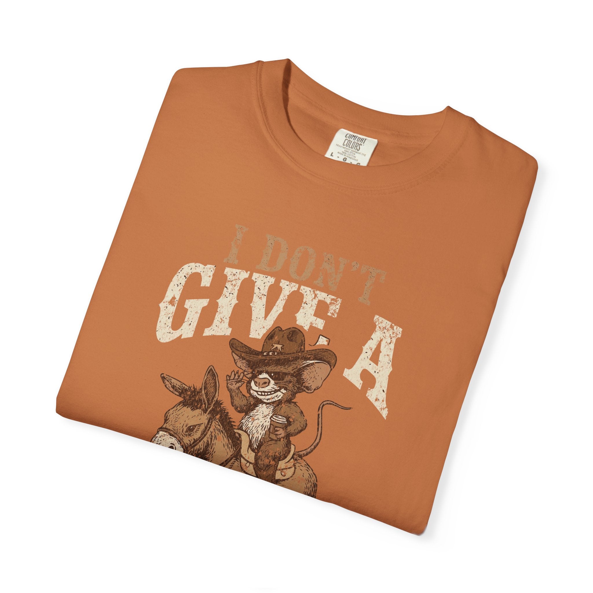 Orange t-shirt featuring a distressed graphic of a cowboy rat riding a donkey.