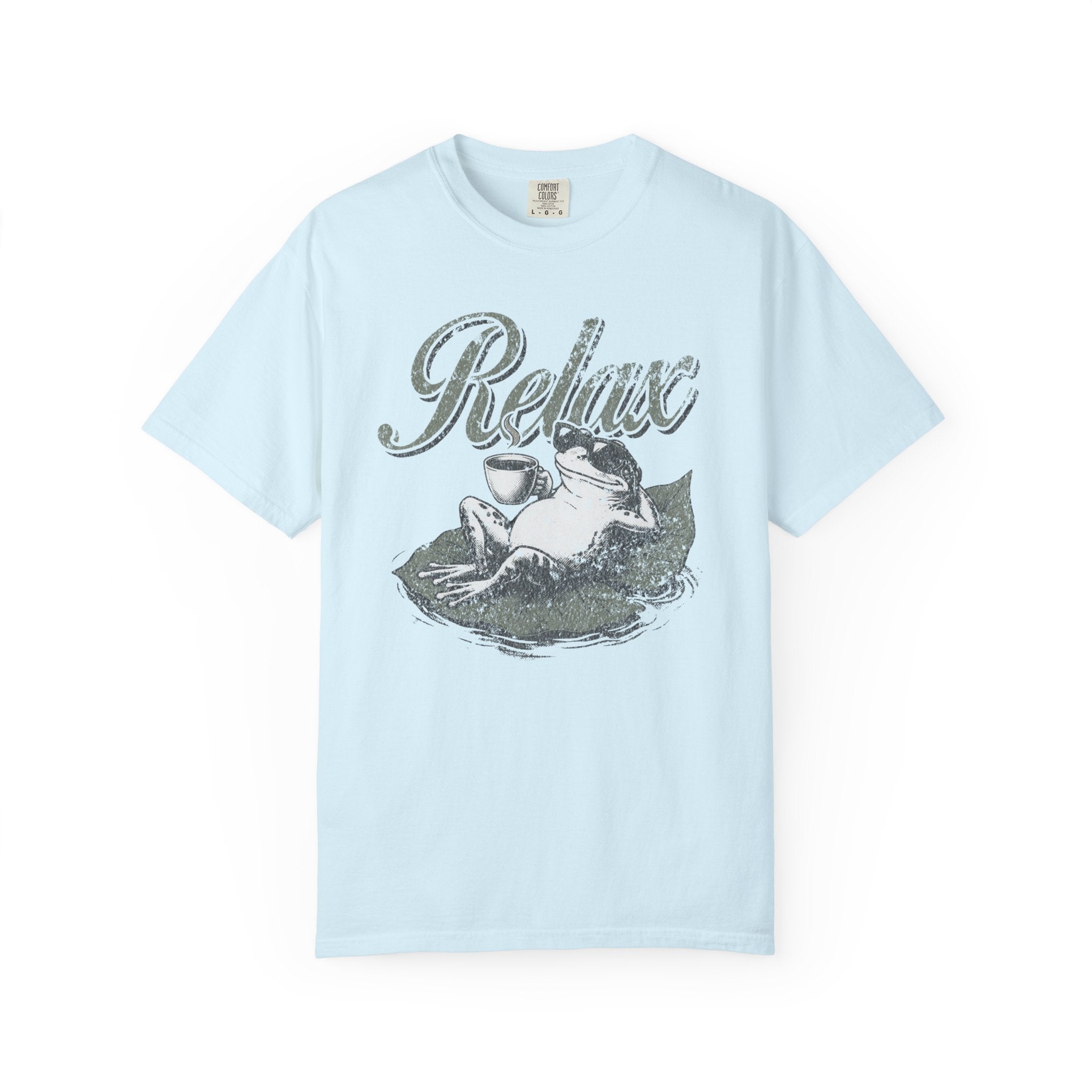 Light blue unisex t-shirt featuring a distressed graphic of a frog wearing sunglasses on a lily pad.
