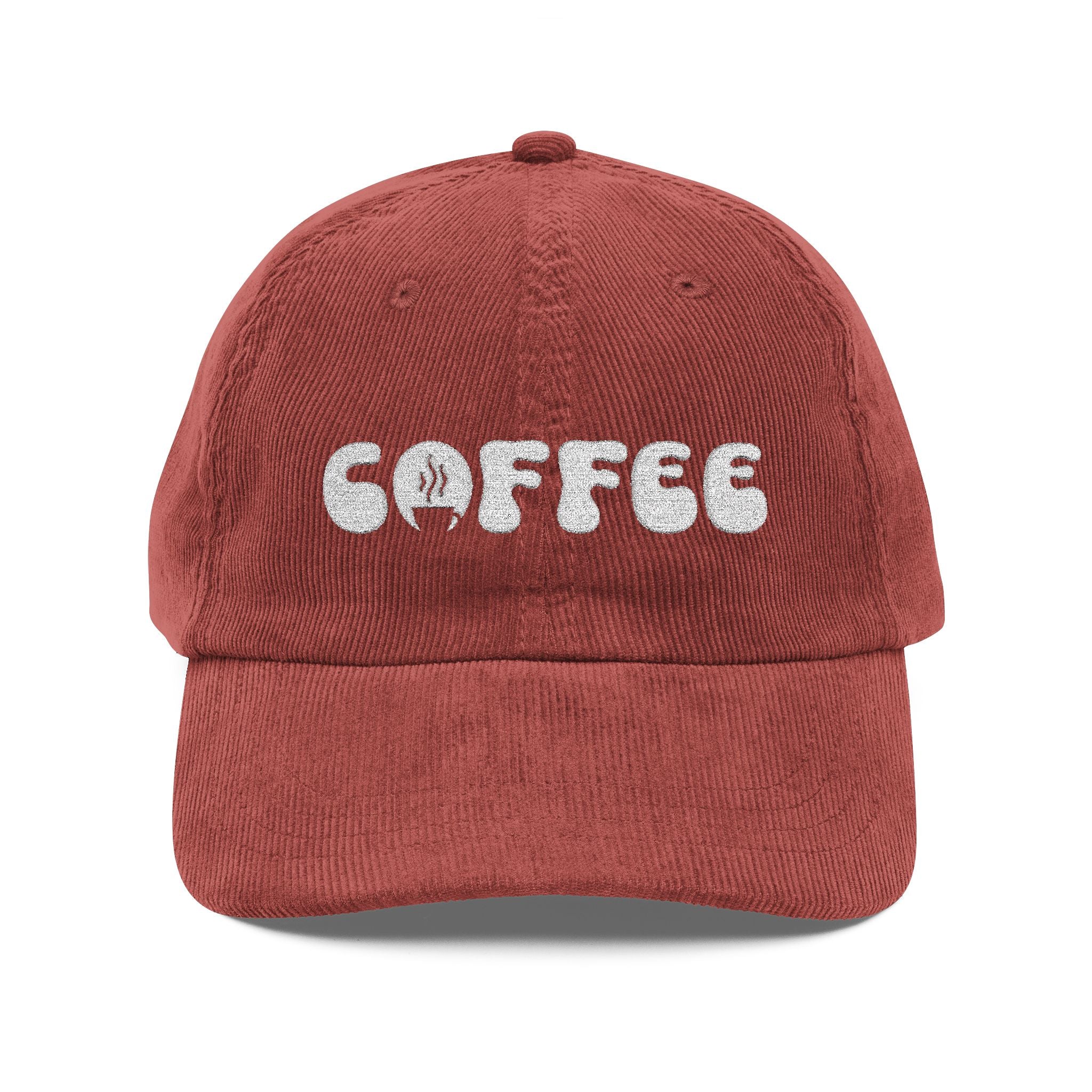 A rust-colored corduroy dad hat with the word COFFEE embroidered in white on the front.