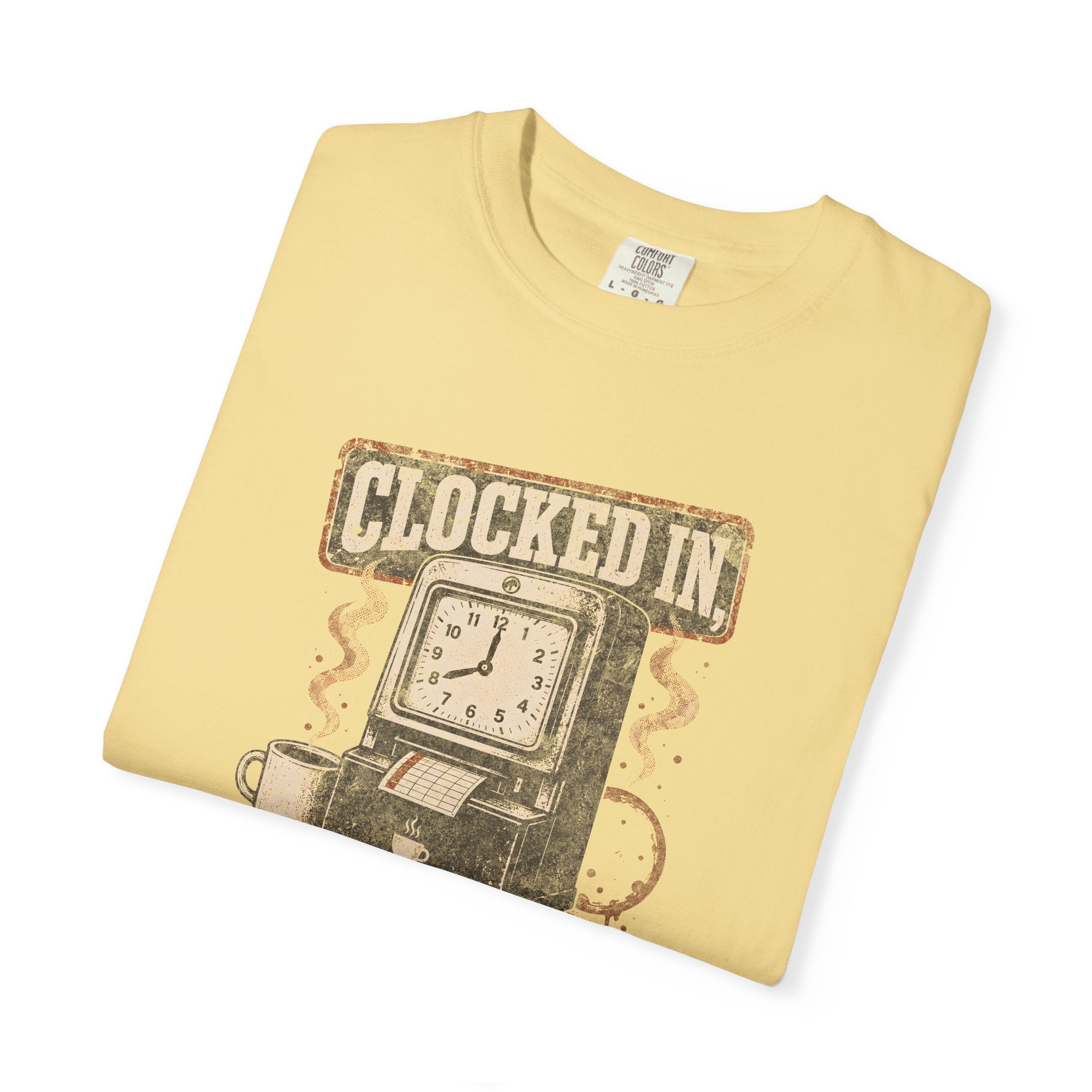A light yellow Comfort Colors t-shirt featuring a vintage graphic of a time clock and coffee cup.