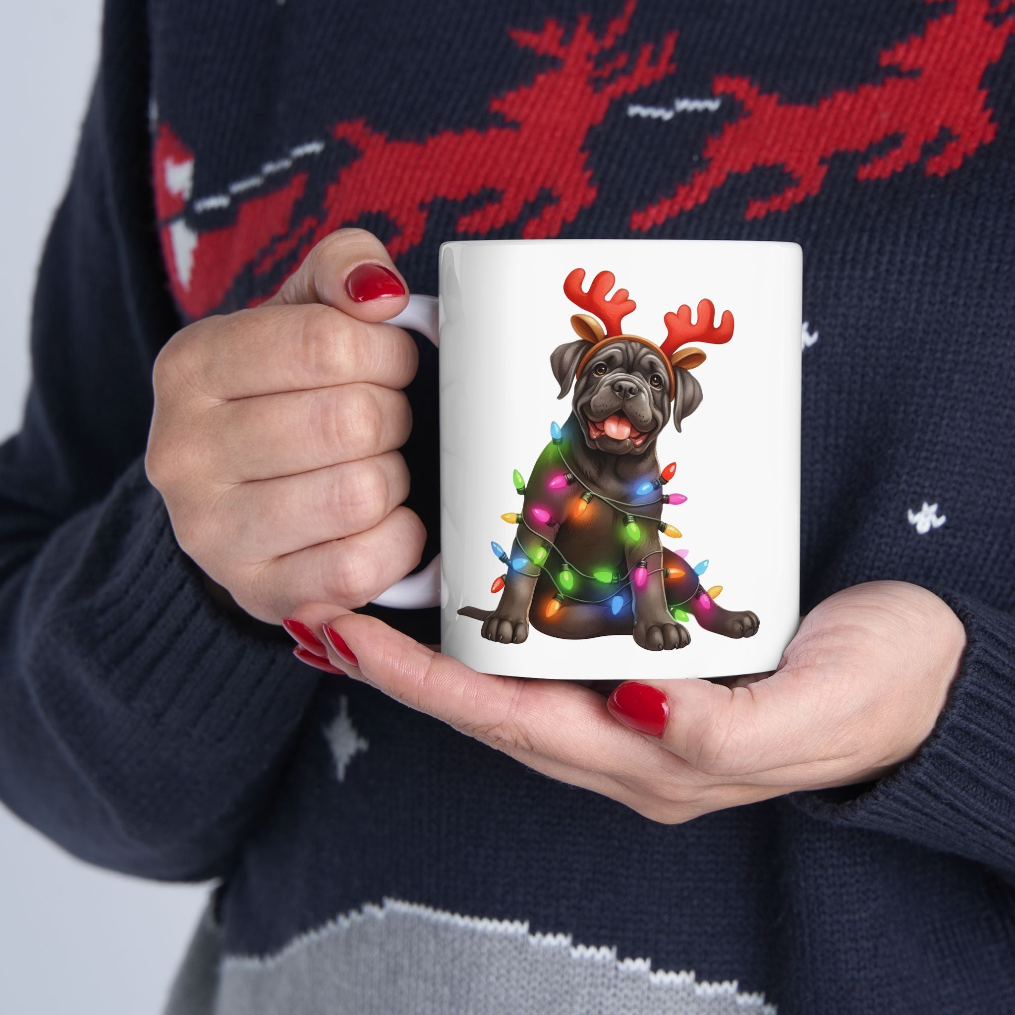 A white mug with a Cane Corso wearing antlers and Christmas lights.