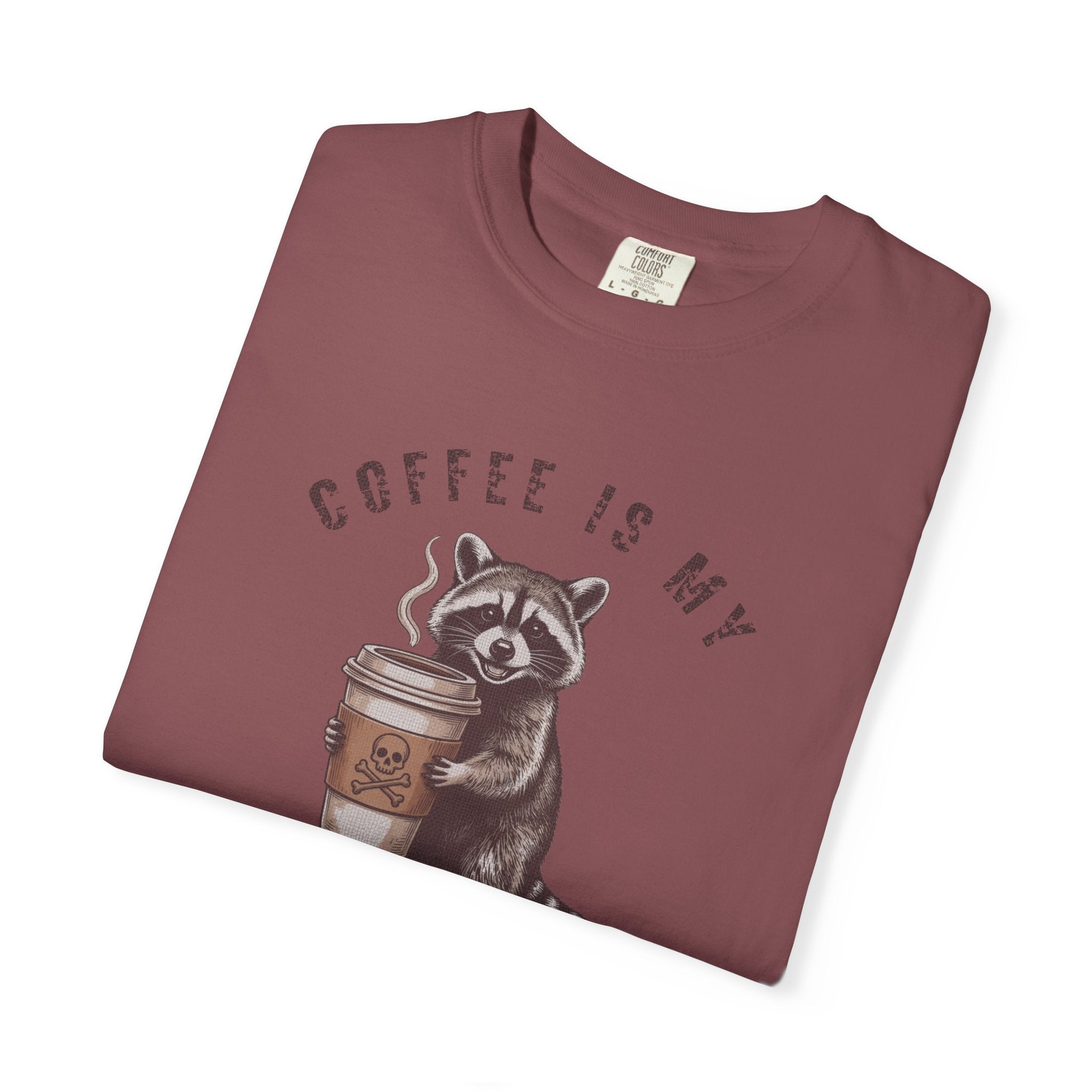 Maroon unisex cotton t-shirt featuring a raccoon holding a coffee cup with a skull and crossbones.
