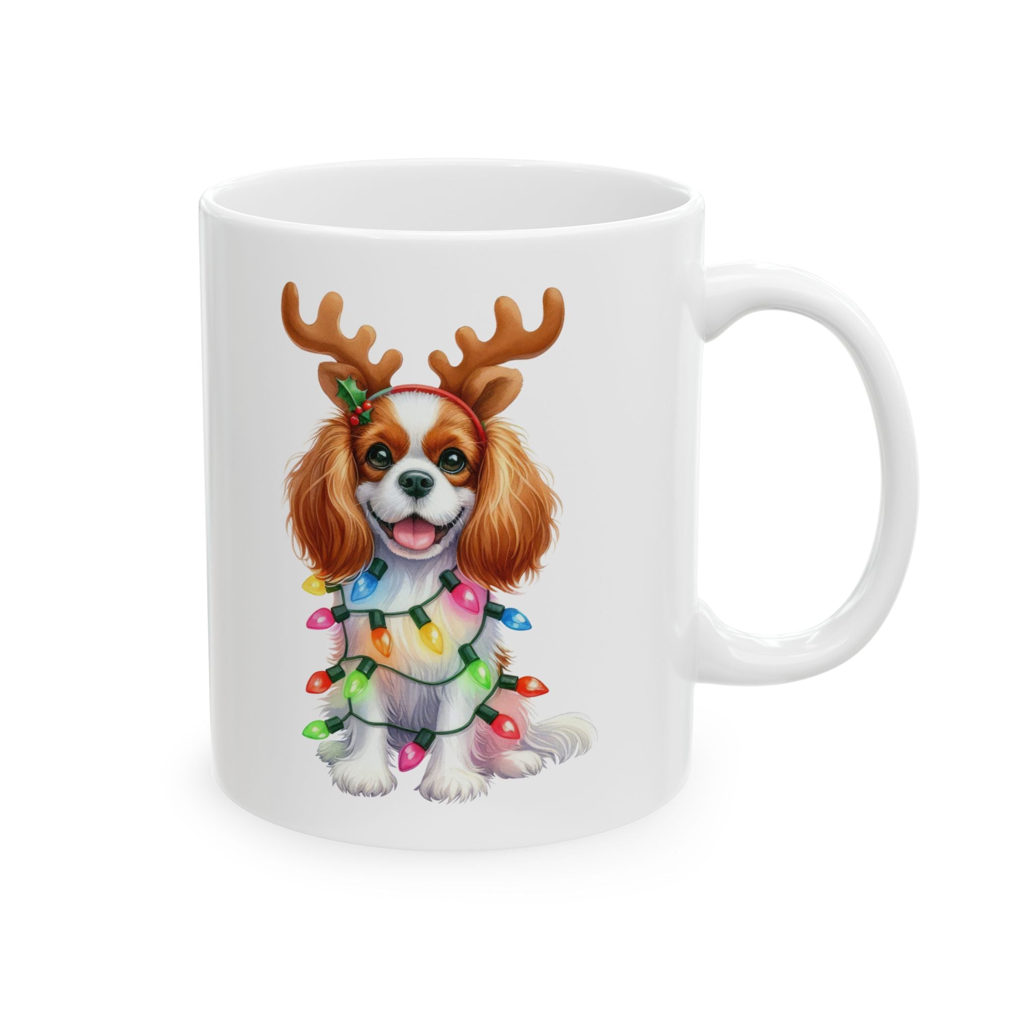 White ceramic mug featuring a Cavalier King Charles Spaniel wearing reindeer antlers and Christmas lights.