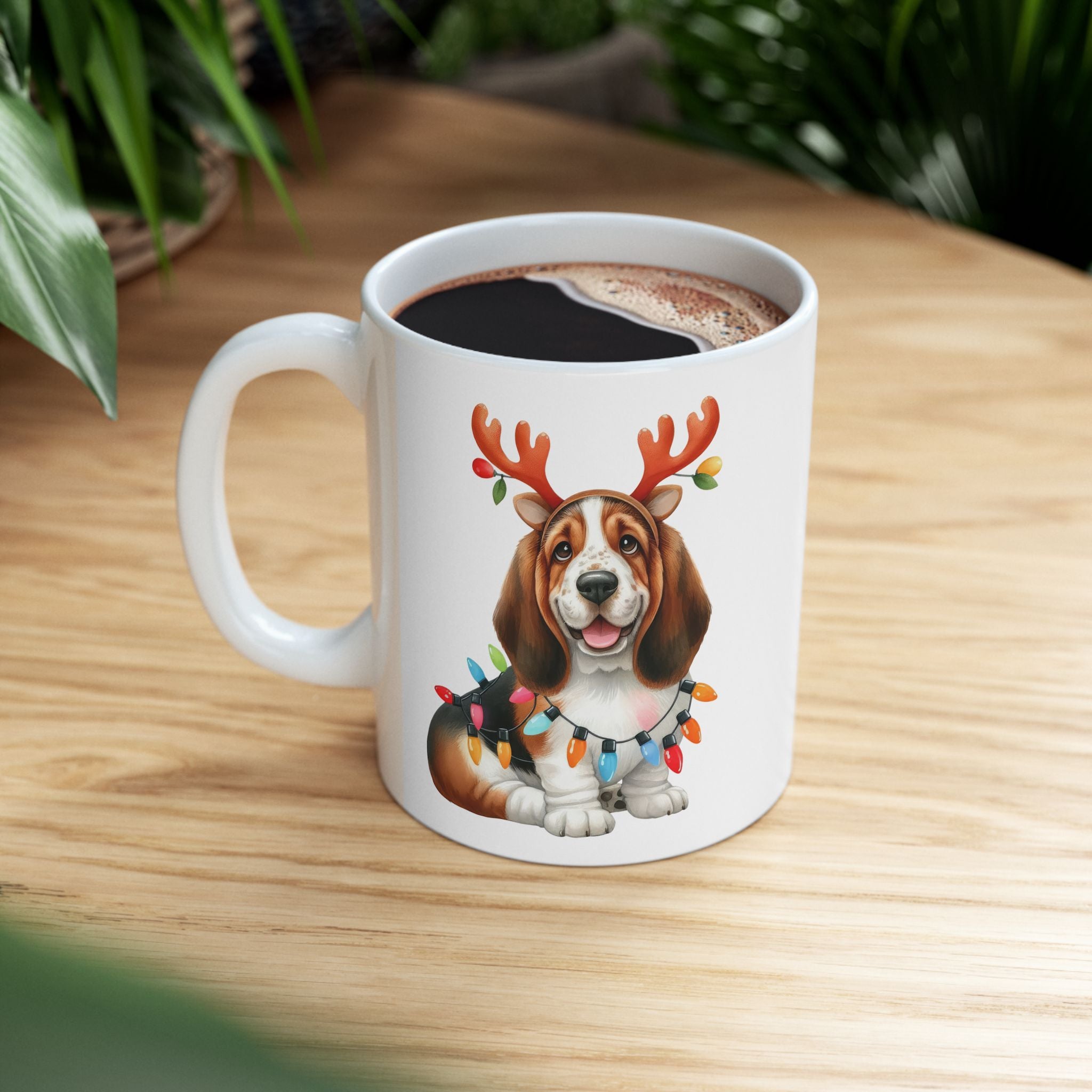 White ceramic mug with a Basset Hound wearing reindeer antlers and Christmas lights.