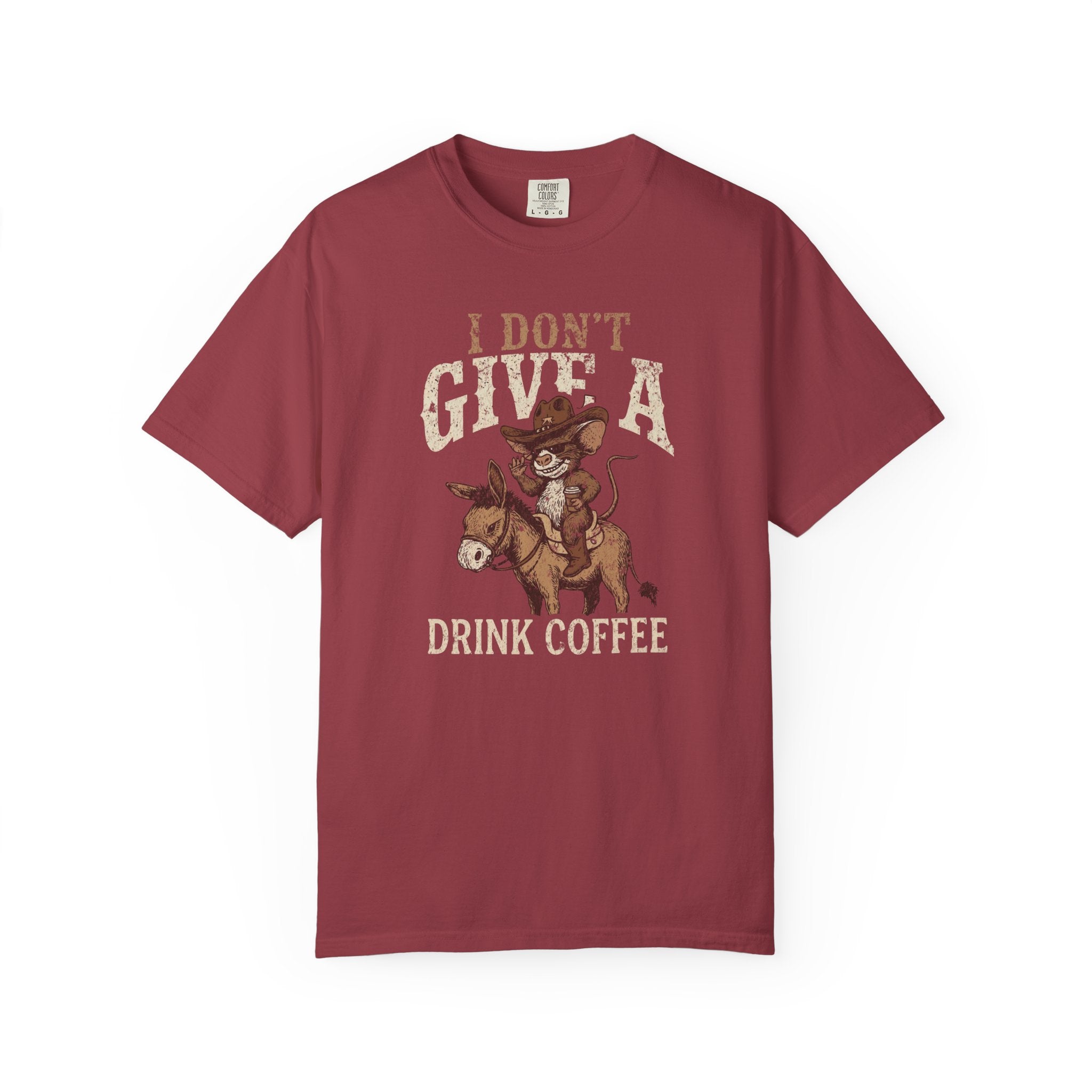 Maroon t-shirt featuring a graphic of a rat in a cowboy hat riding a donkey holding coffee.