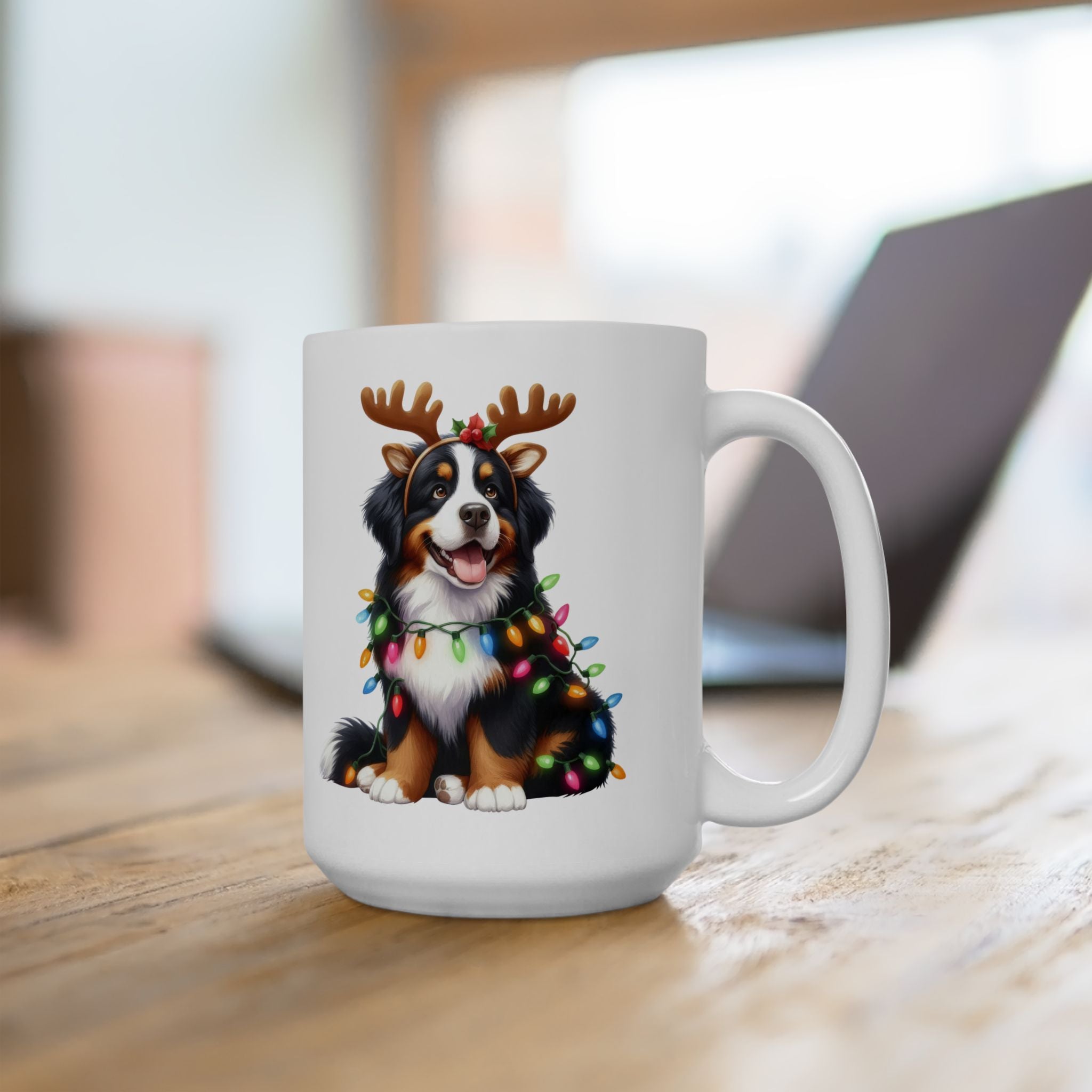 White ceramic mug with a Bernese Mountain Dog wearing reindeer antlers and Christmas lights.
