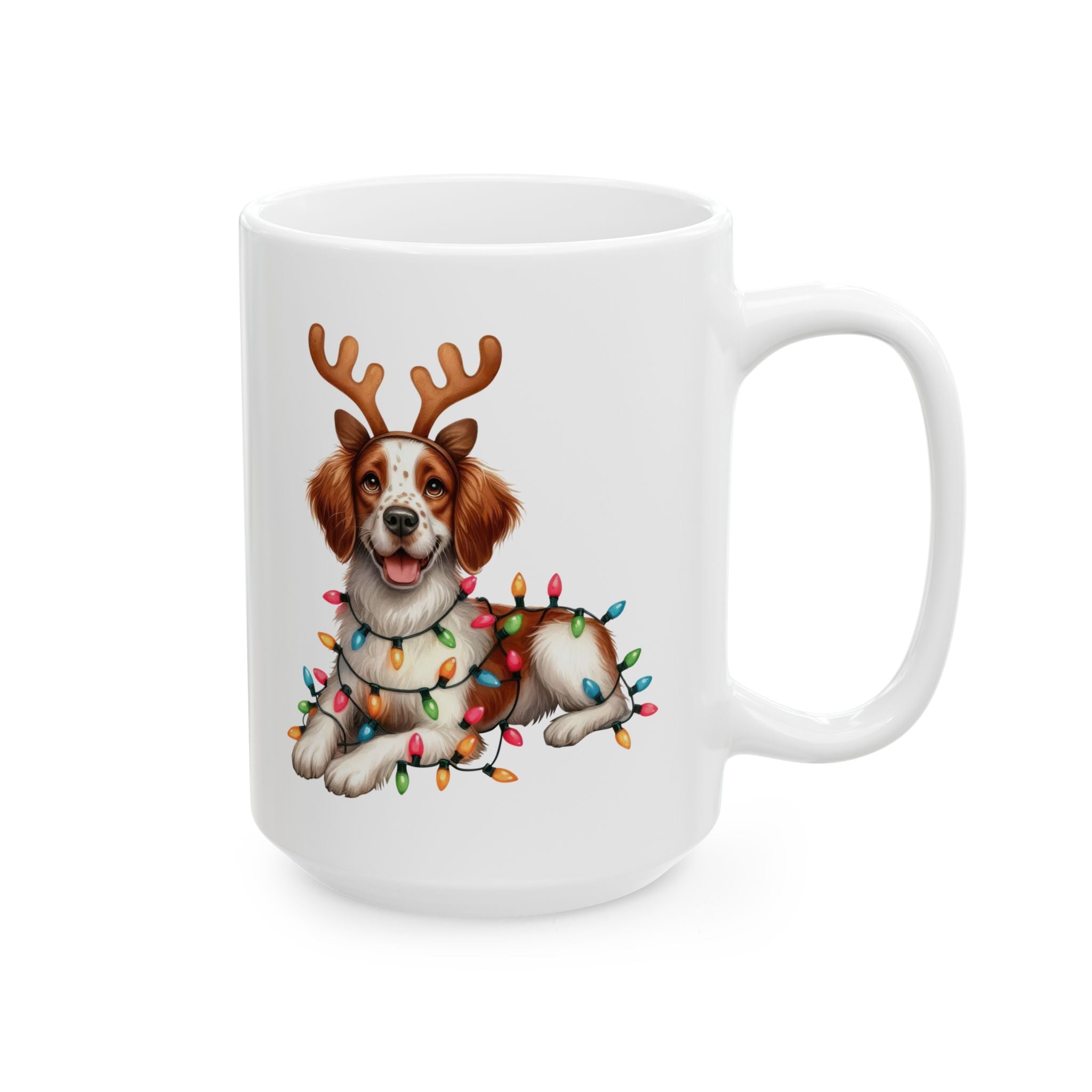 A white ceramic mug features a Brittany dog wearing reindeer antlers and Christmas lights.