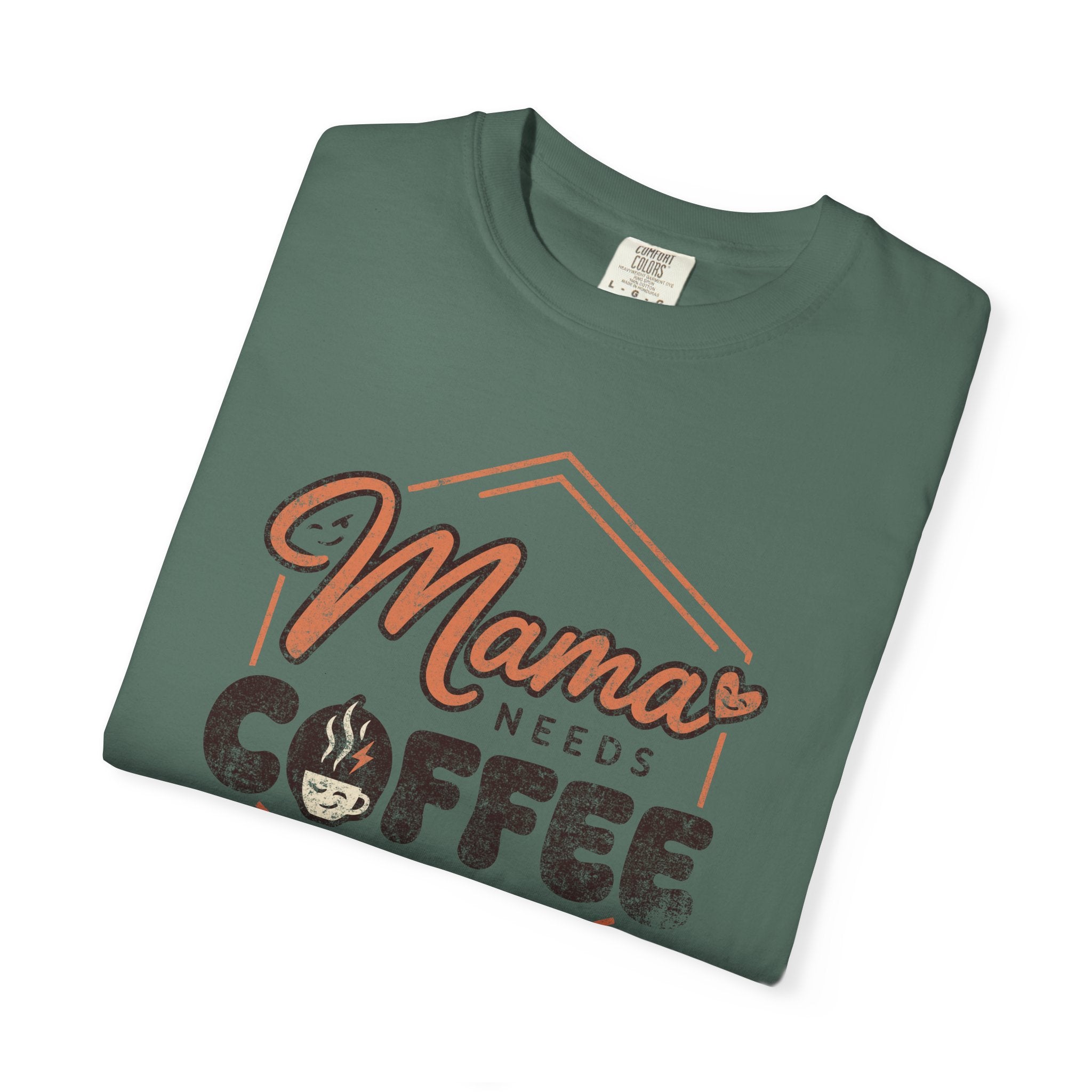 Folded green unisex t-shirt with a distressed Mama Needs Coffee graphic print.