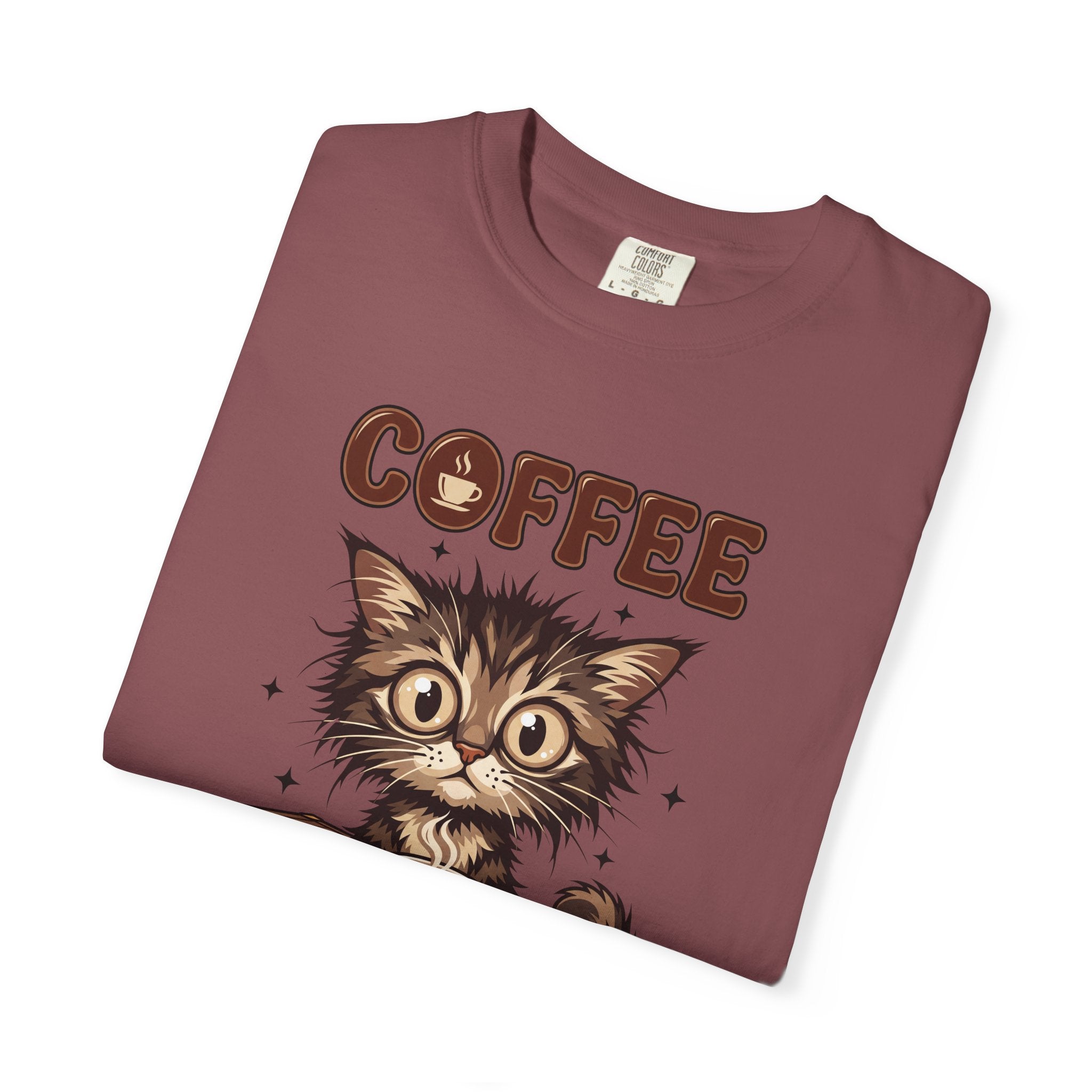 A folded maroon unisex cotton t-shirt featuring a graphic of a wide-eyed kitten and the word COFFEE.