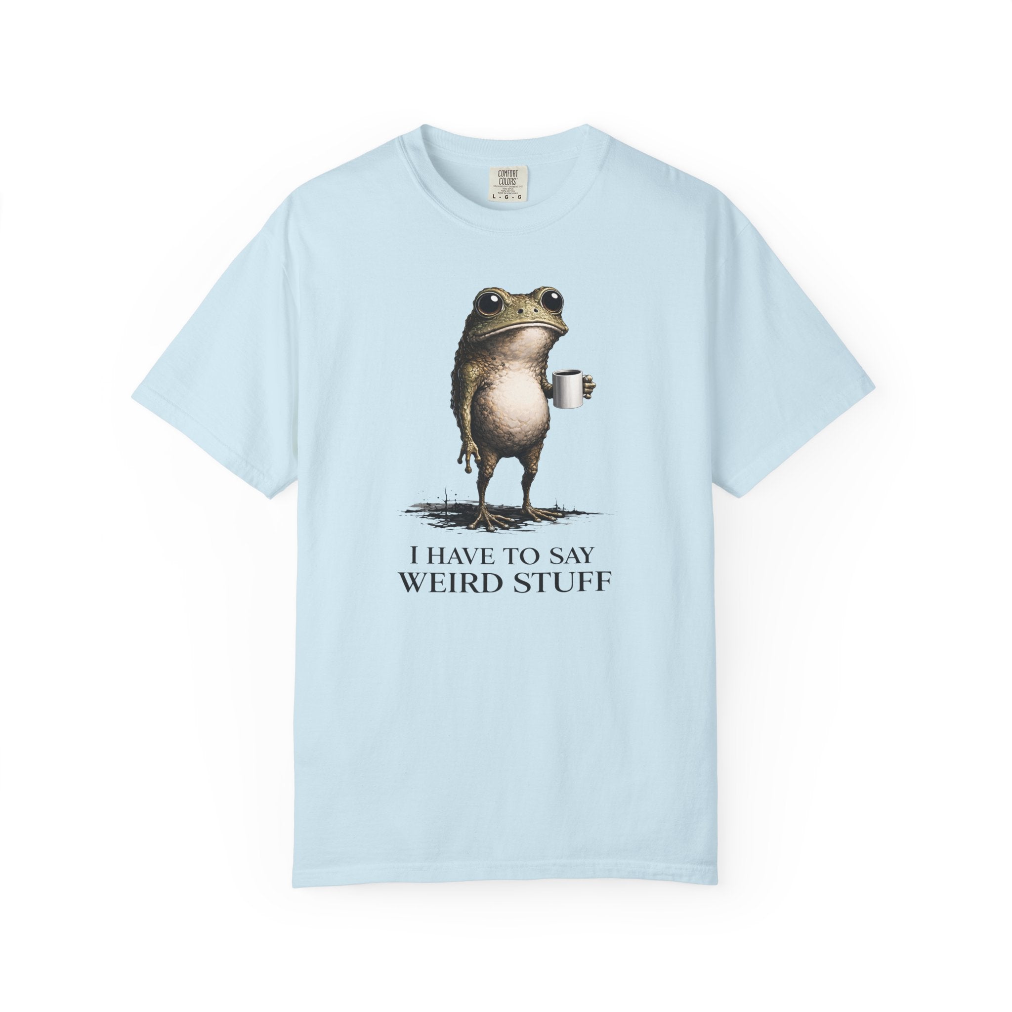A light blue t-shirt featuring a graphic of a frog holding a coffee mug with the text I have to say weird stuff.