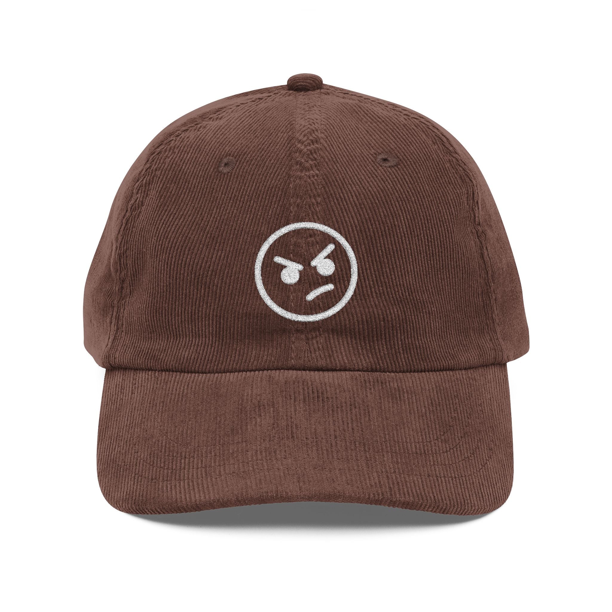 A brown corduroy dad hat featuring an embroidered white angry face emoji on the front.