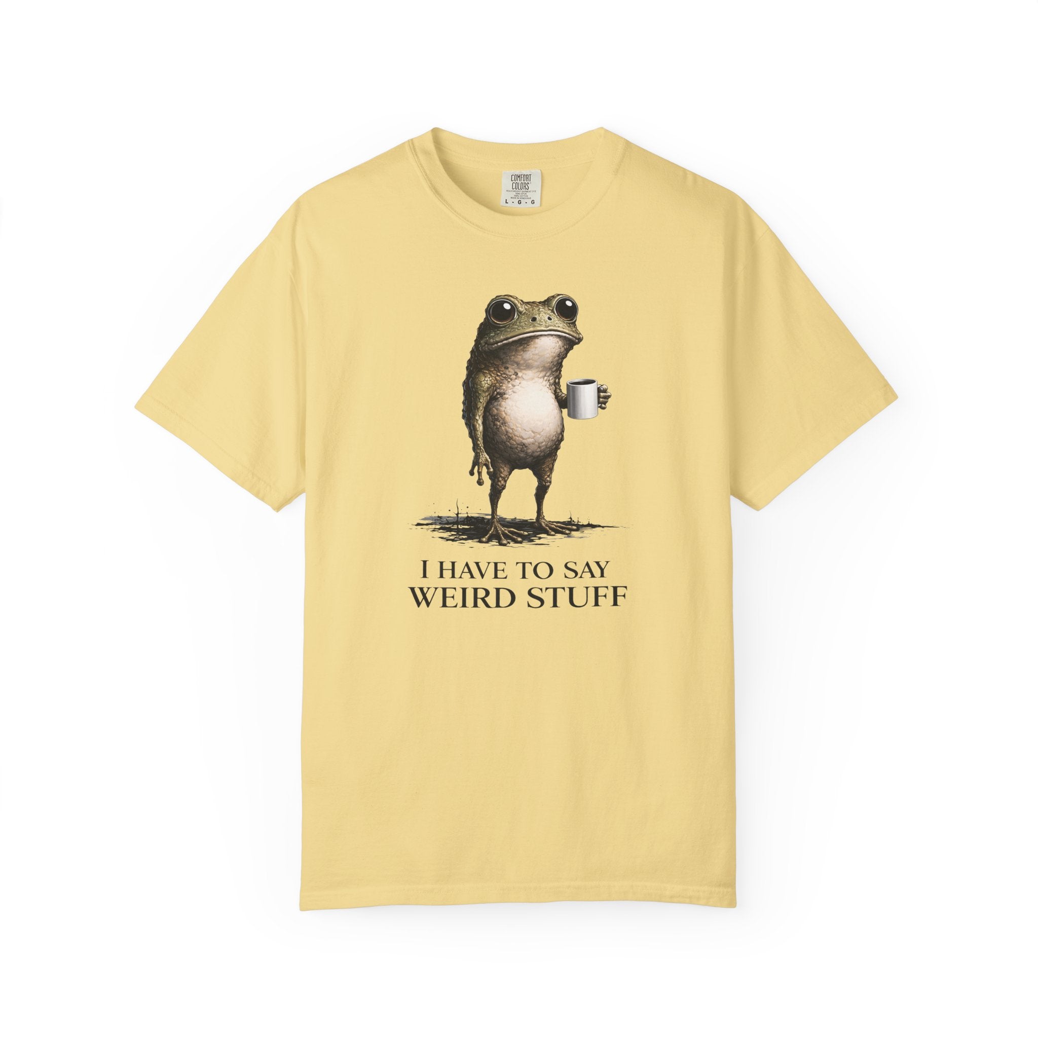 A light yellow cotton t-shirt featuring a graphic of a frog holding a coffee mug.